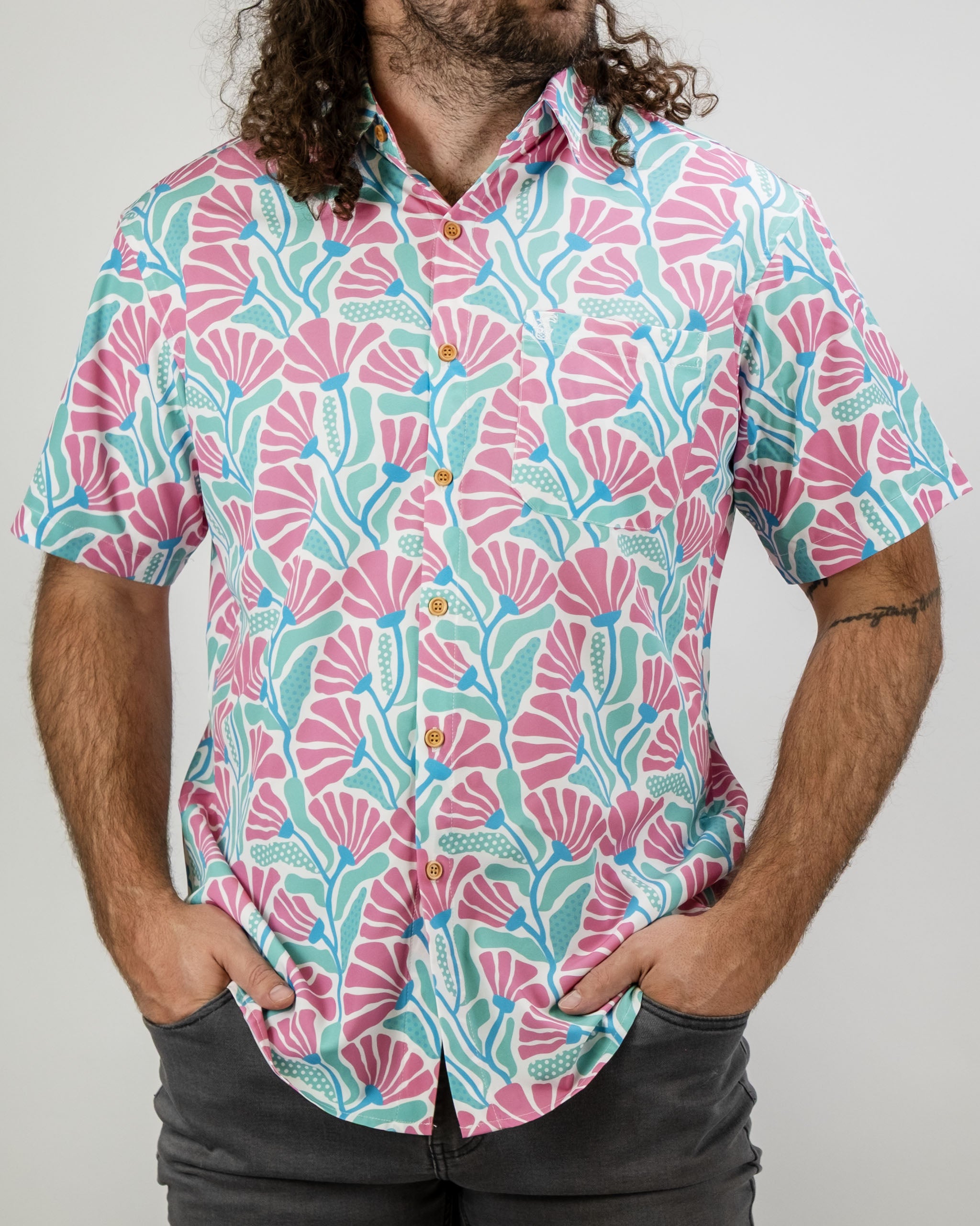 Men's short-sleeve shirt featuring a vibrant coral and teal floral pattern, perfect for stylish golf outings.
