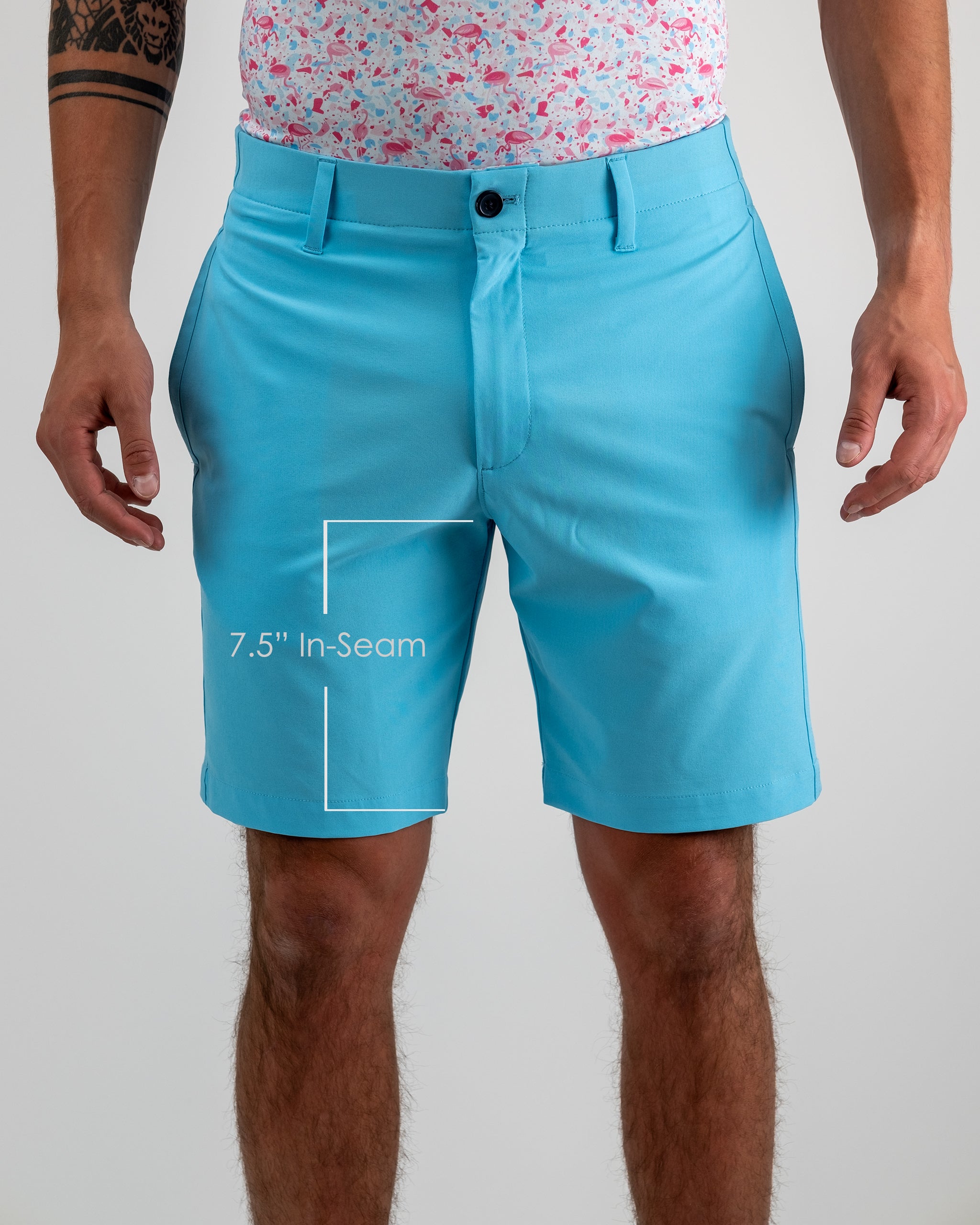 Bright blue golf shorts with a 7.5" inseam, styled with a colorful flamingo-print shirt for bold, standout golf fashion.