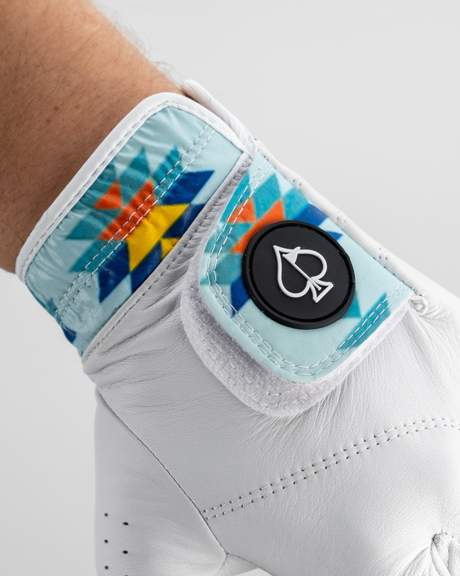 Colorful, geometric golf headcover with a bold logo, featuring bright blue, orange, yellow, and white design elements.