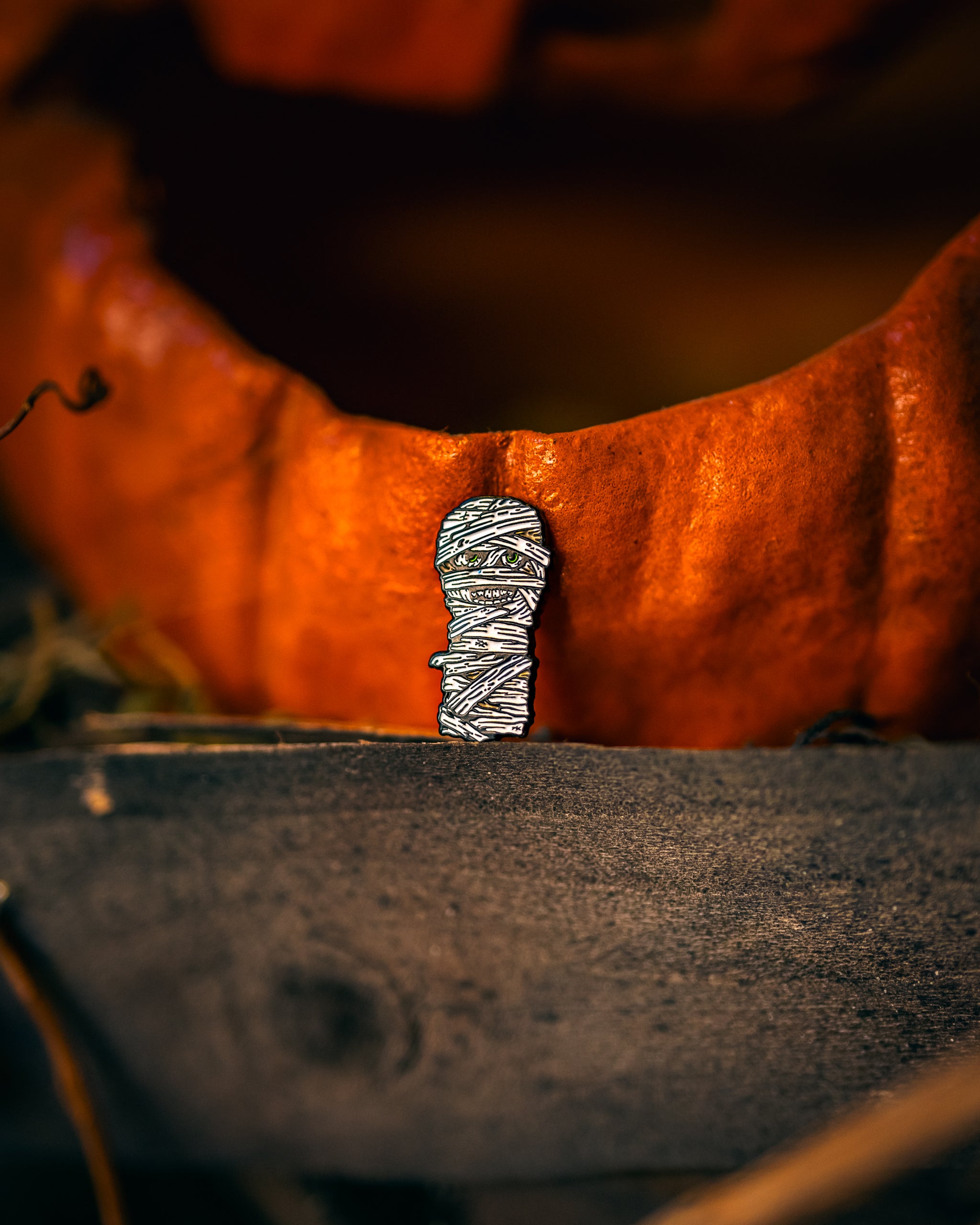 Mummy-themed ball marker for golf, featuring a cute wrapped design with eyes.