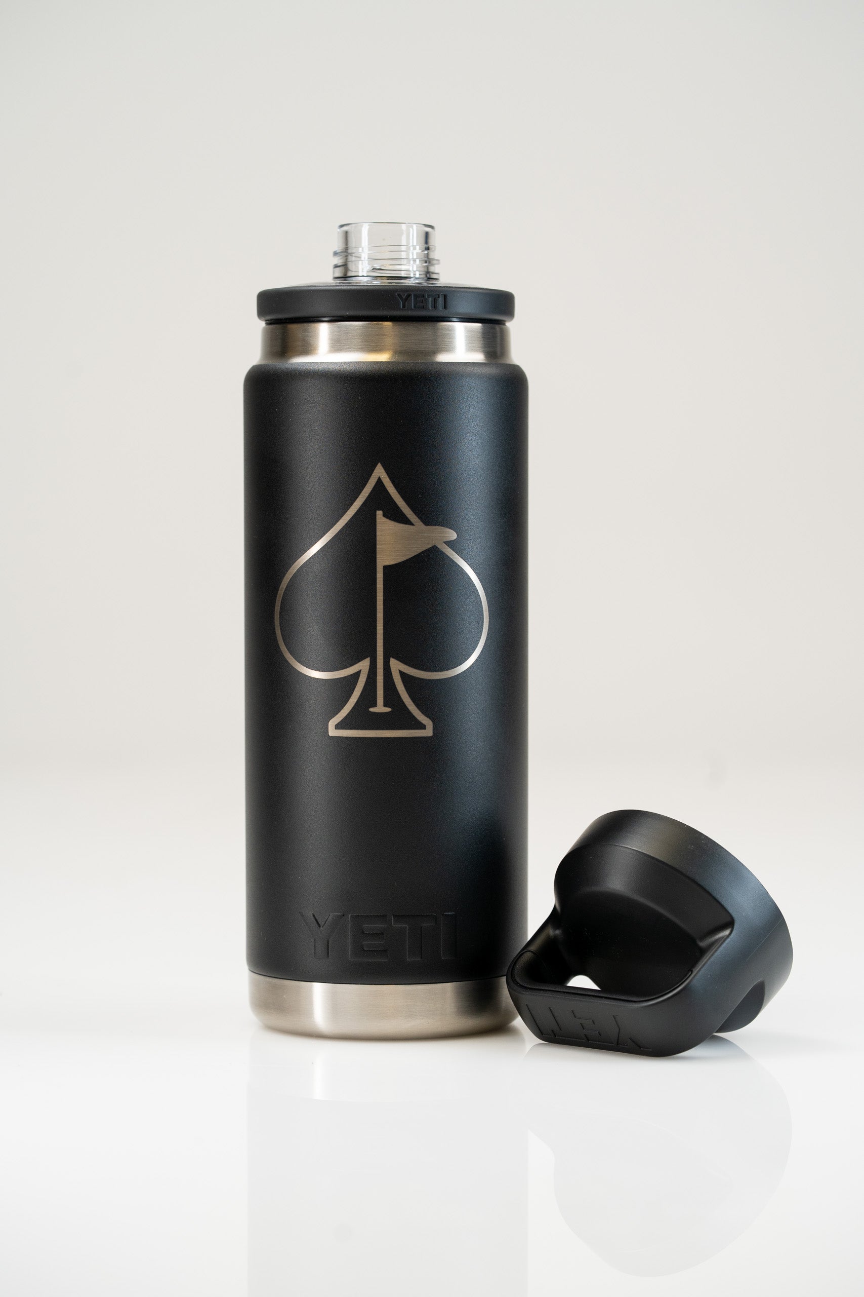 Yeti Rambler water bottle with Chug Cap, featuring a sleek black design and a spade logo, ideal for golfers.