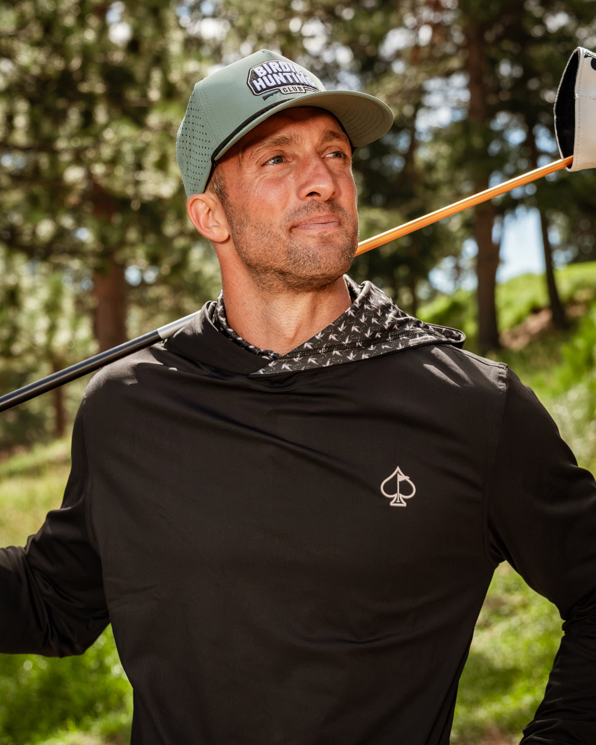 Men's performance golf hoodie in black with a stylish hood, featuring a duck hook design, perfect for golfers seeking comfort and style.