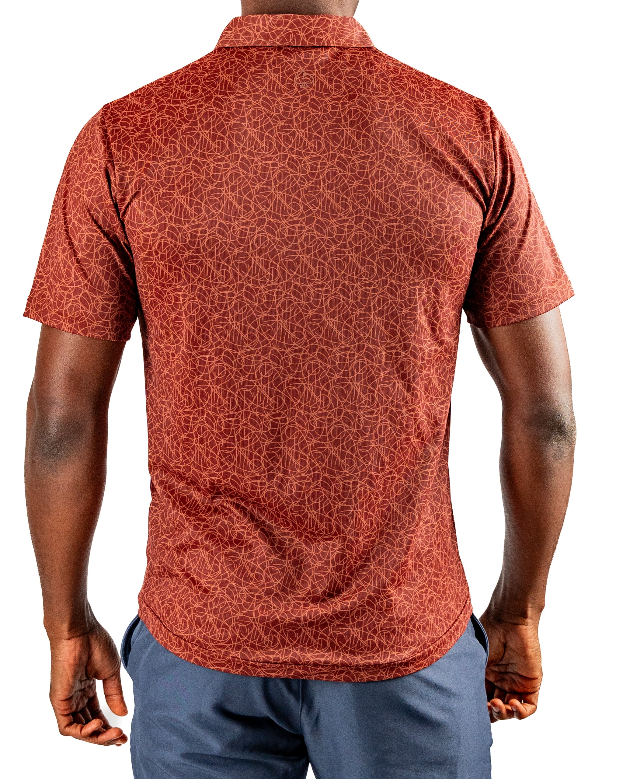 Men's short-sleeve golf shirt in a rich rust color featuring a geometric pattern, designed for bold style on the course.