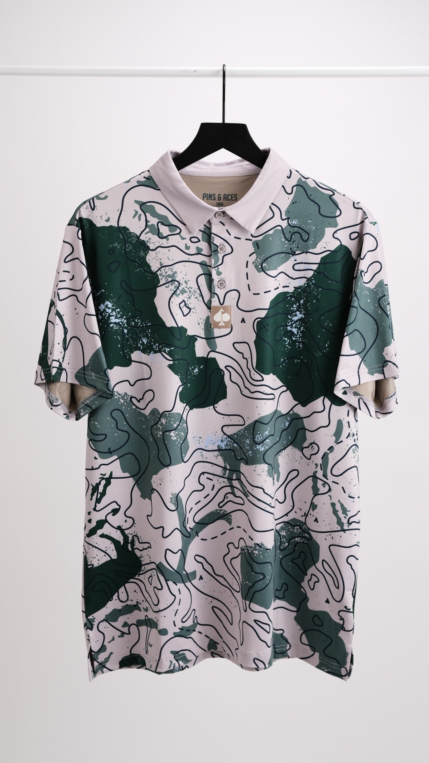 Bold golf polo featuring a unique topographic design in green and pink, perfect for golfers seeking standout style.