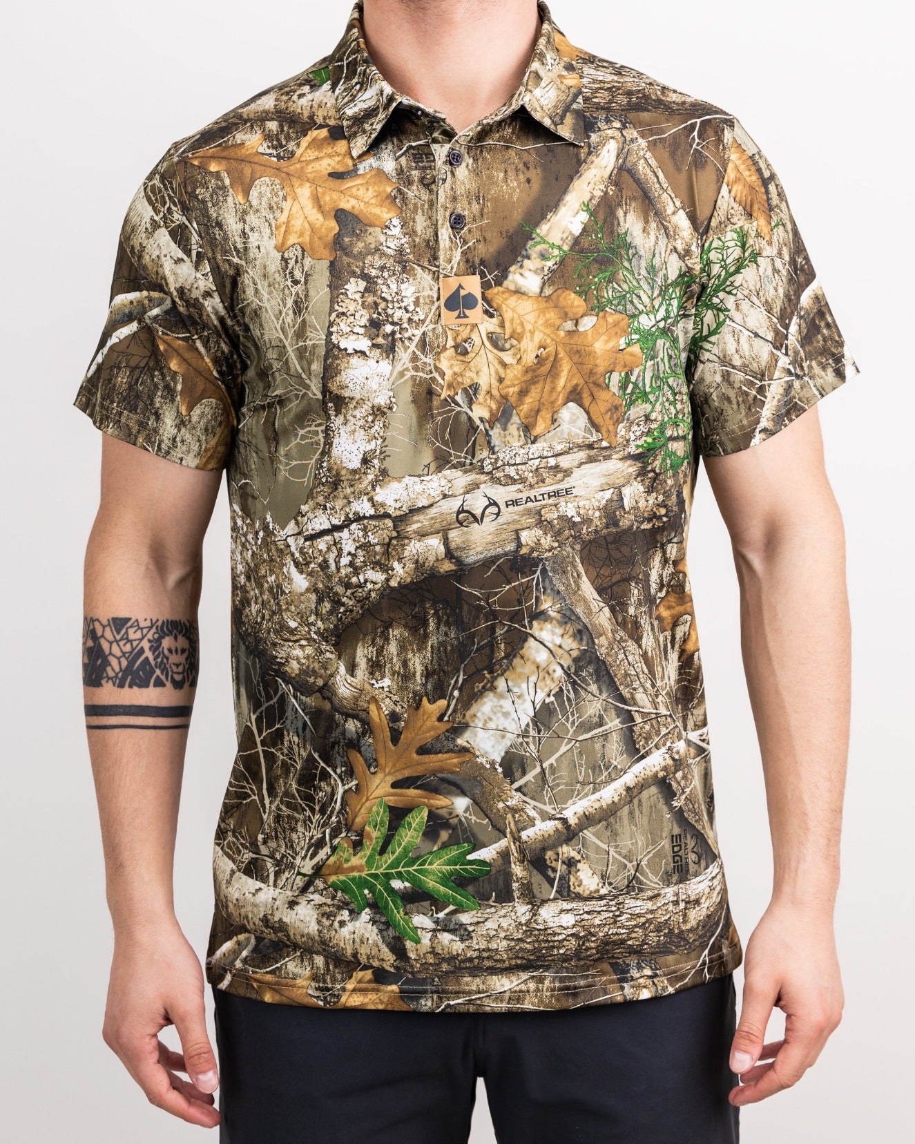 Men's Realtree Edge Polo featuring a camouflage pattern with natural elements, perfect for stylish outdoor golf wear.