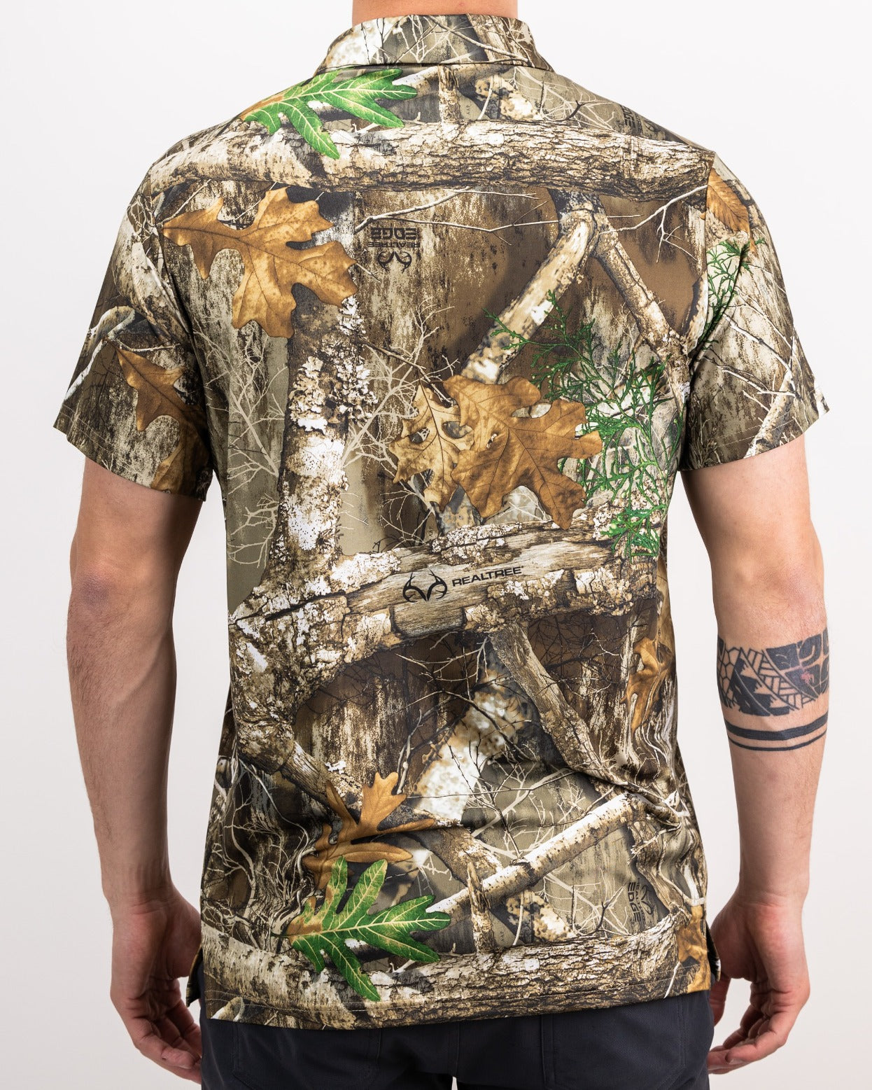 Men's Realtree Edge Polo featuring a realistic camouflage pattern with leaves and branches, ideal for outdoor enthusiasts.