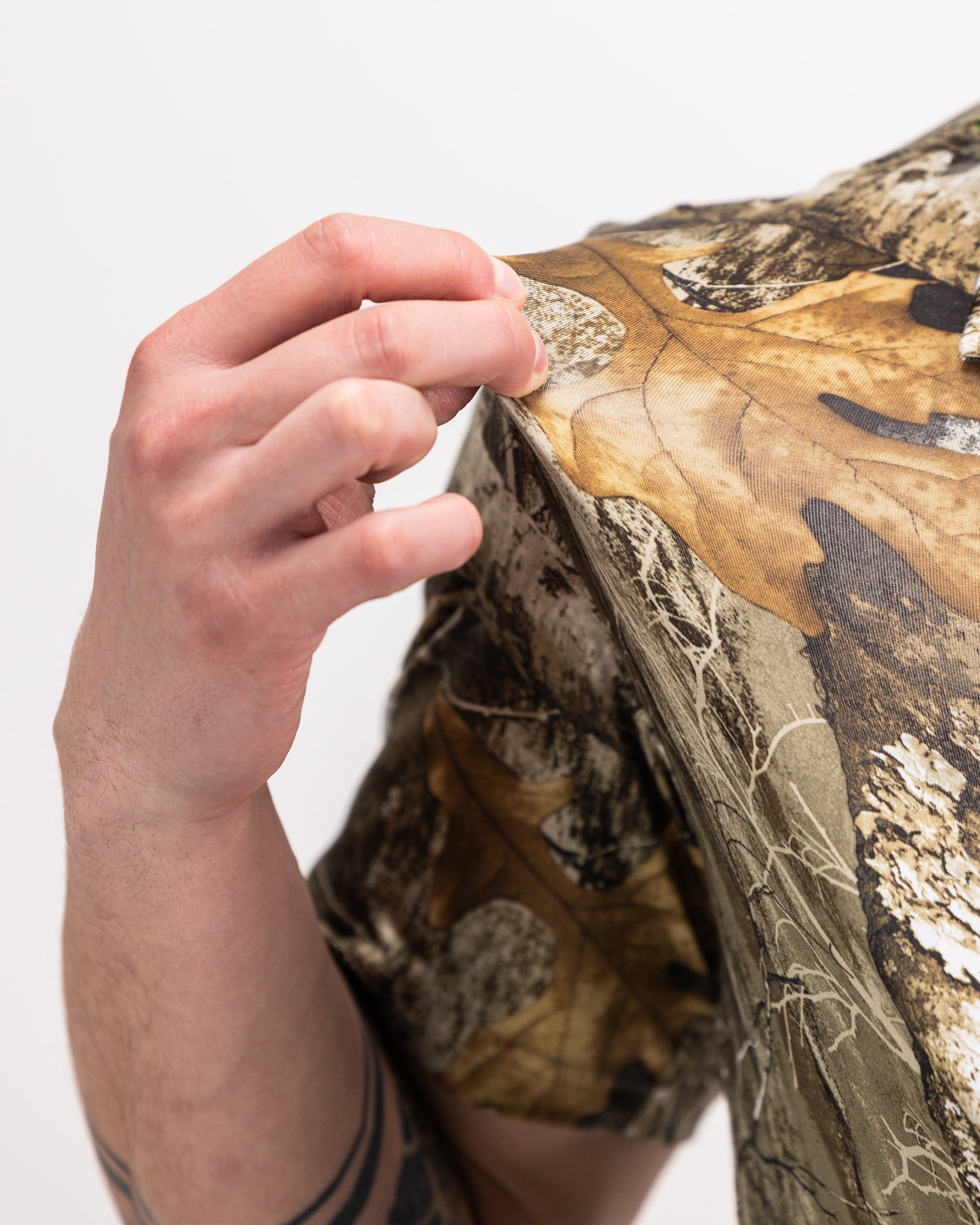 Men's Realtree Edge Polo featuring a camouflage design with natural leaf patterns, perfect for outdoor golfing.