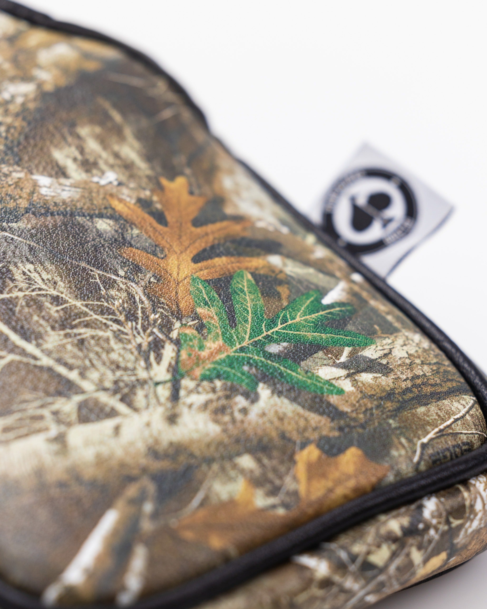 Realtree mallet cover featuring a camouflage design with leaves and branches, perfect for golfers who enjoy outdoor aesthetics.