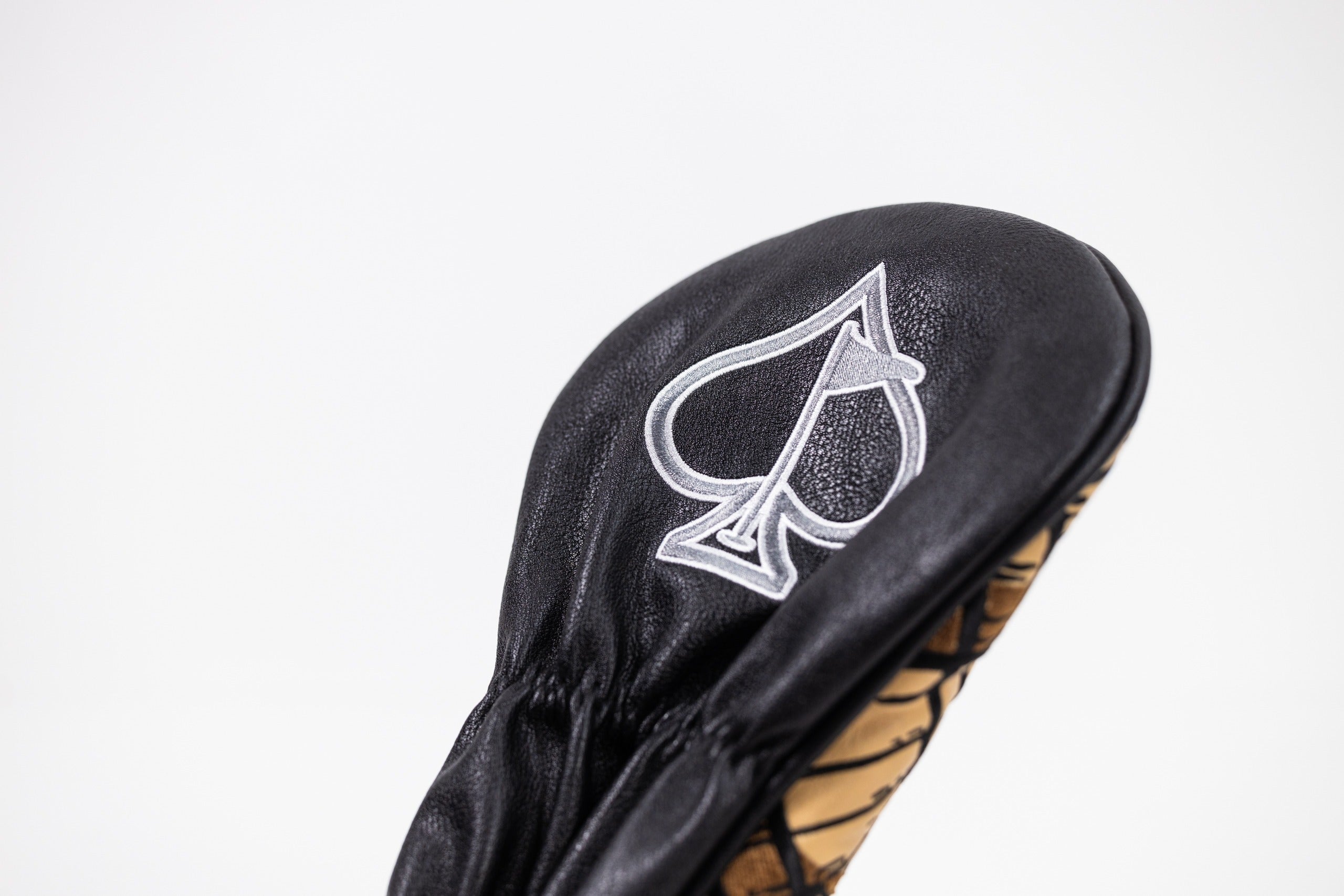 Bourbon Barrel Driver Cover featuring a sleek black design with a spade logo, perfect for stylish golfers.