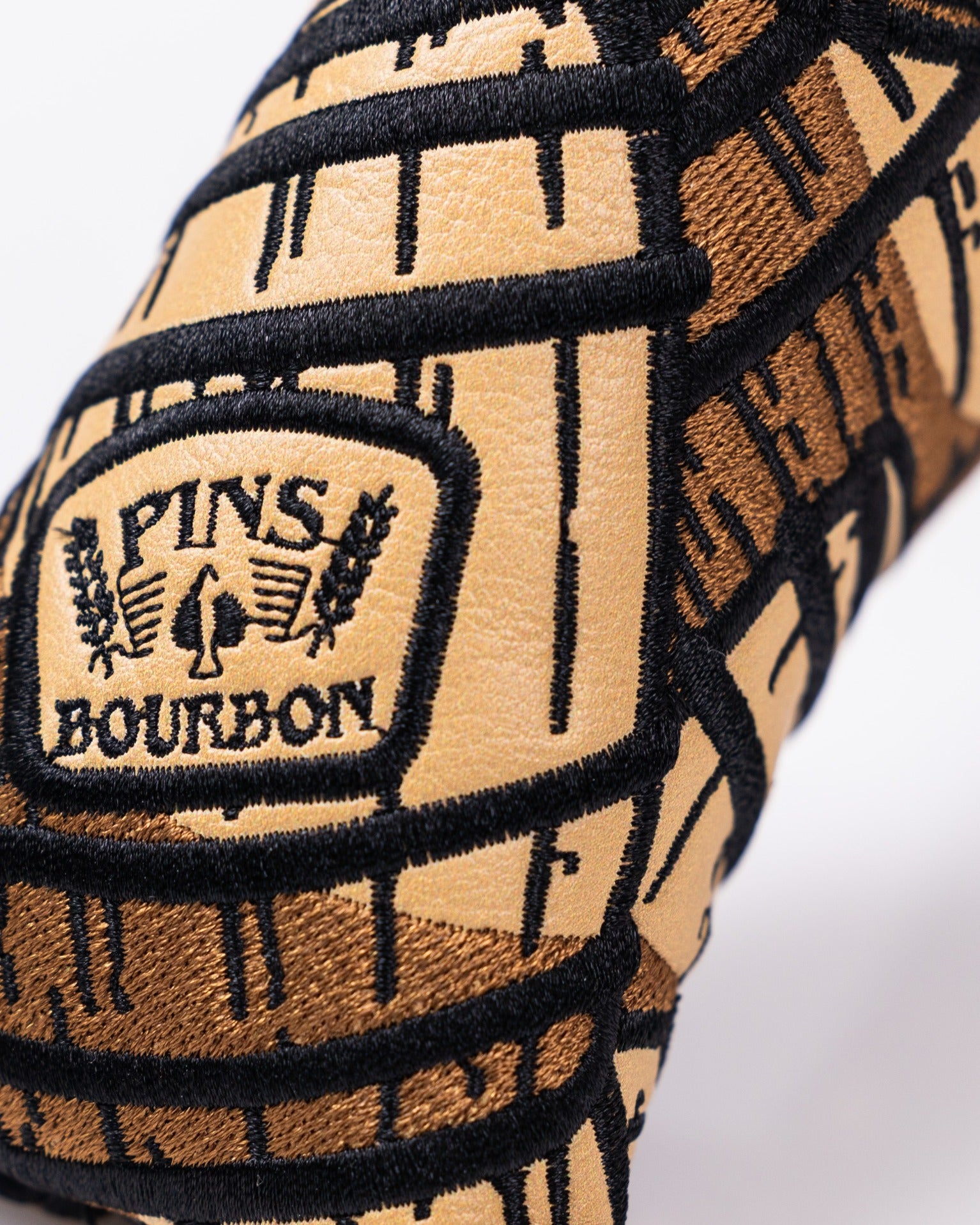 Bourbon Barrel Blade Putter Cover featuring a stylish barrel design and embroidered Pins Bourbon logo for golfers.
