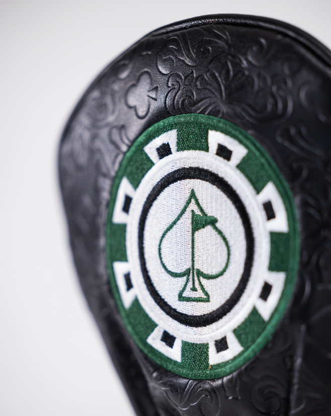 Blackjack driver cover featuring an embossed black design and a green and white spade logo, perfect for stylish golfers.