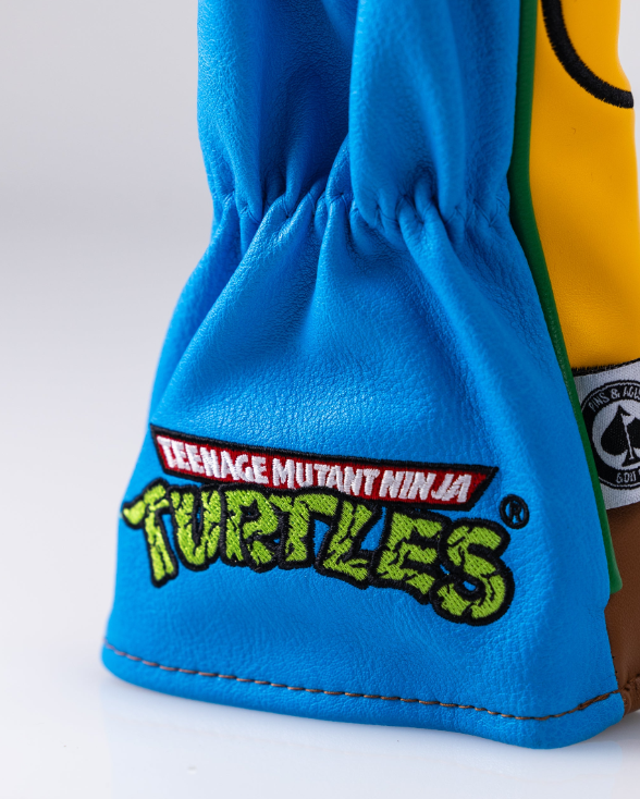 Leonardo hybrid golf cover featuring vibrant blue fabric and Teenage Mutant Ninja Turtles logo for a fun, bold look.