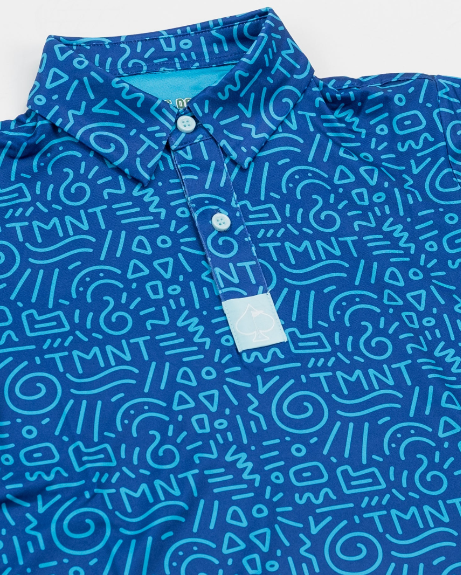 Youth polo shirt featuring a vibrant blue design with playful doodles and patterns, perfect for young golf enthusiasts.