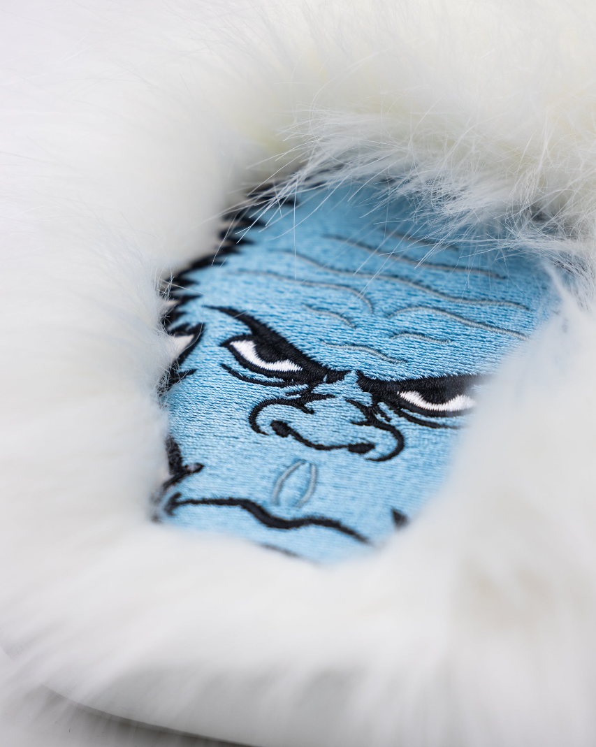 Yeti mallet cover featuring a blue yeti face design with a fluffy white exterior for added protection on the golf course.