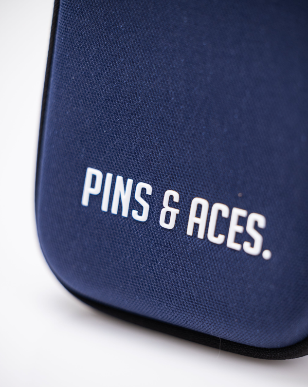 Navy glove and accessory caddie featuring the Pins & Aces logo, designed for golfers to organize their gear stylishly.