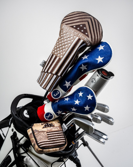 Folds of Honor 2.0 mallet putter cover featuring patriotic designs, displayed on a golf bag with various clubs and headcovers.