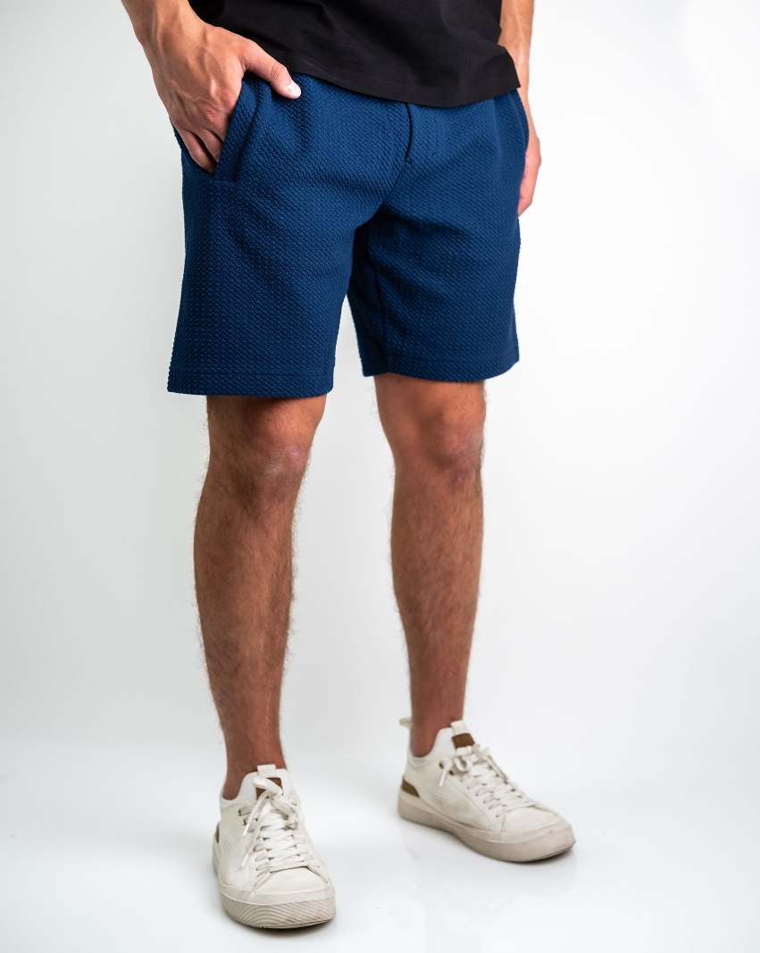 Navy waffle knit shorts with pockets, designed for comfort and style, paired with white sneakers. Ideal for casual outings.