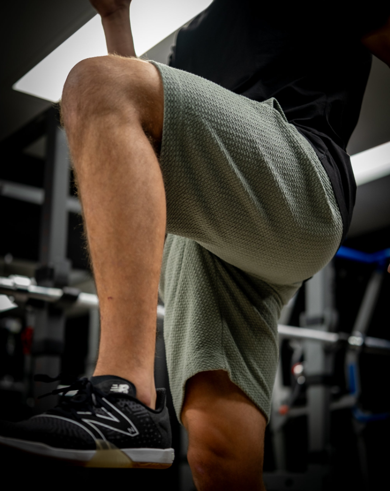 Player Preferred Waffleknit Shorts in sage color, showcasing a close-up of the fabric texture and fit during a workout.