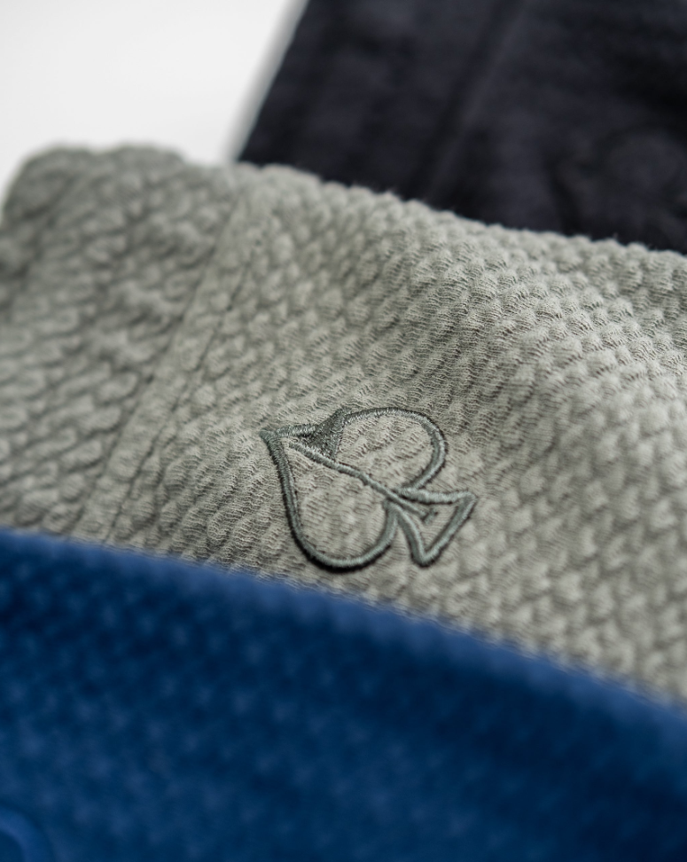 Sage waffleknit shorts featuring a textured fabric and embroidered logo, ideal for stylish comfort on the golf course.