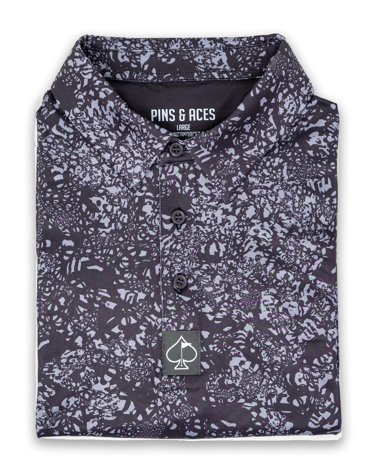 Folded golf shirt featuring a unique volcanic ash pattern in shades of black and gray, designed for bold style on the course.