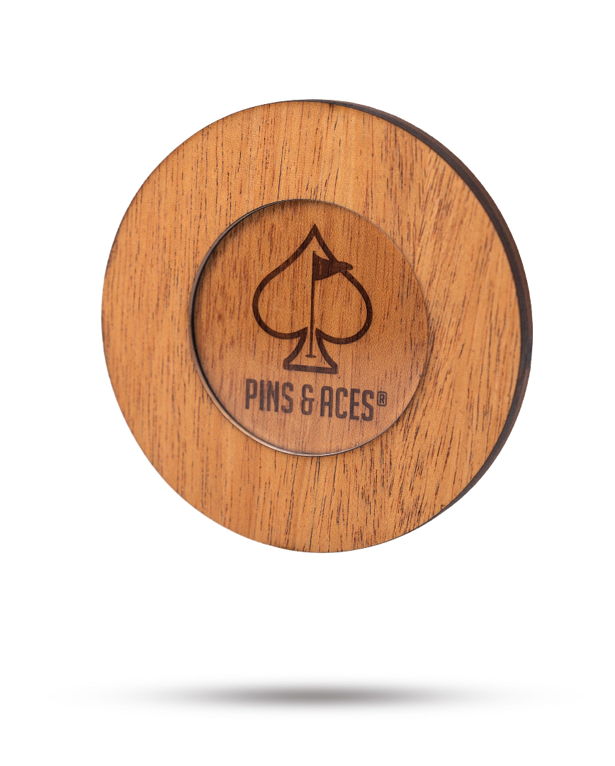 Wooden coaster set featuring the Pins & Aces logo, designed for stylish golf enthusiasts. Perfect for home or on-course use.