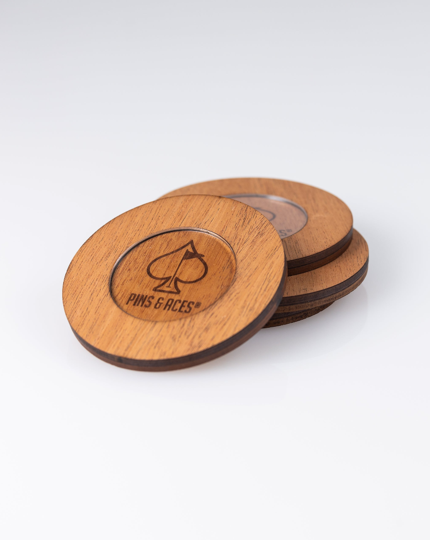 Wooden coaster set featuring the Pins & Aces logo, designed for stylish protection of surfaces while enjoying drinks.