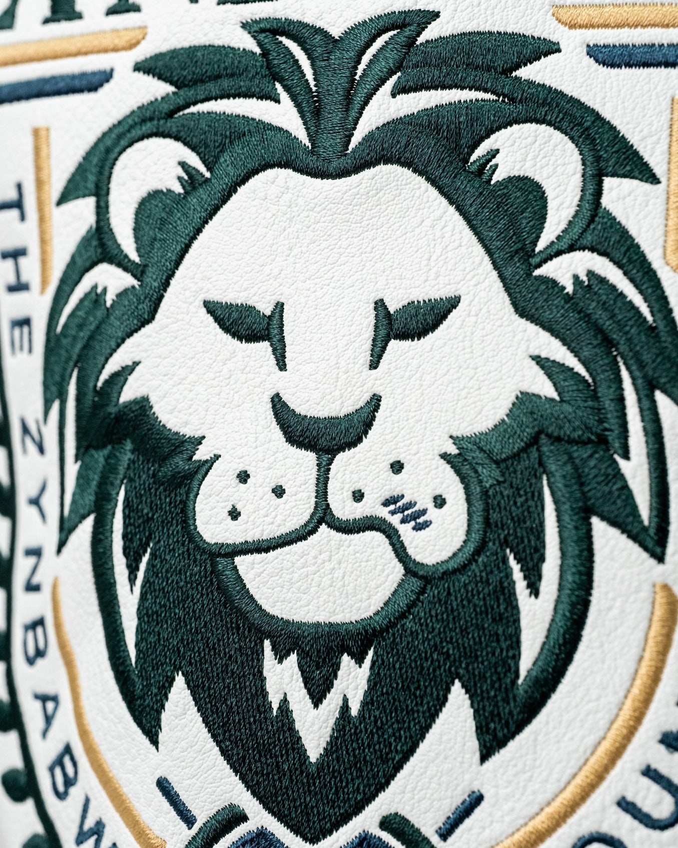 Embroidered driver cover featuring a lion design, representing the Zynbabwe Country Club, in bold green and gold colors.