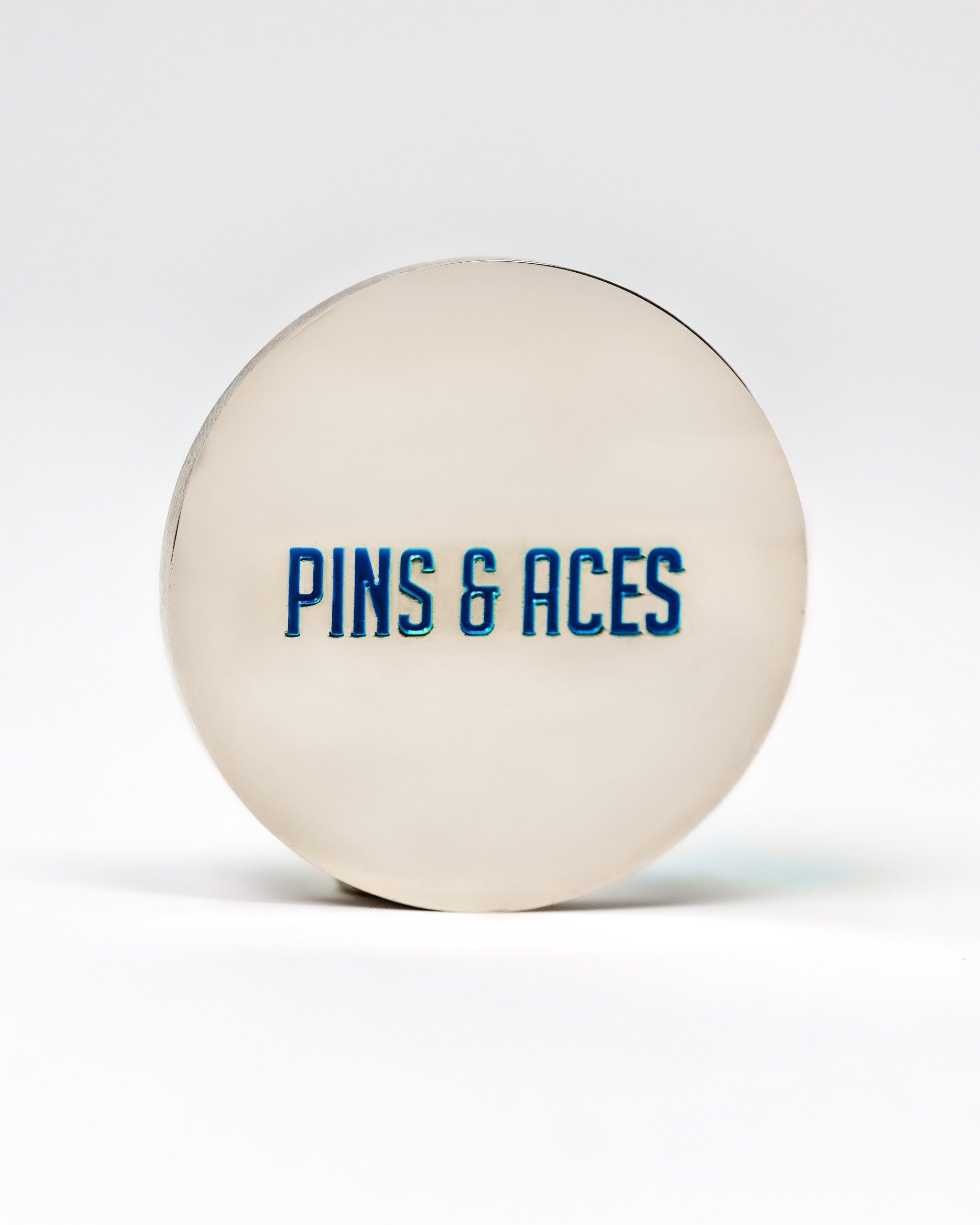 Cool mint ball marker featuring a sleek design with "Pins & Aces" prominently displayed in bold blue lettering.