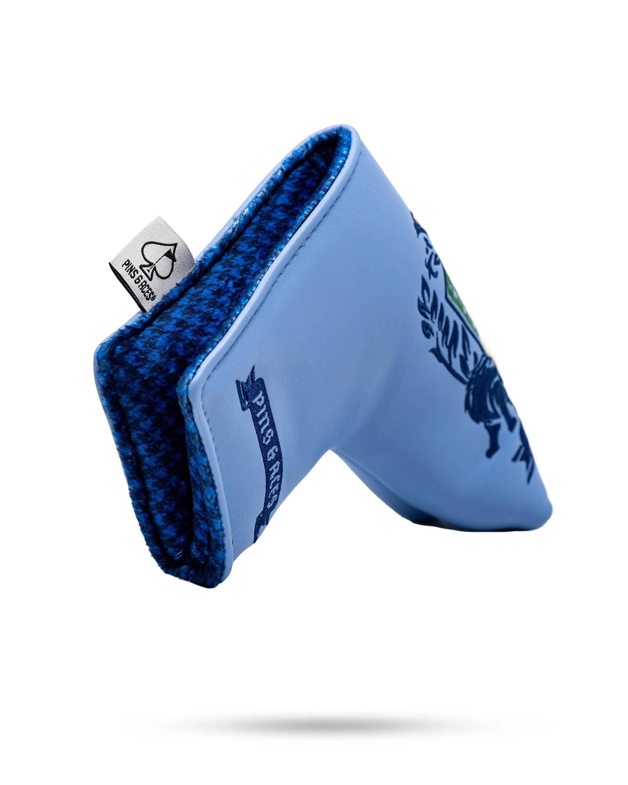 Bold blue blade putter cover featuring a detailed coat of arms design, perfect for stylish golfers.