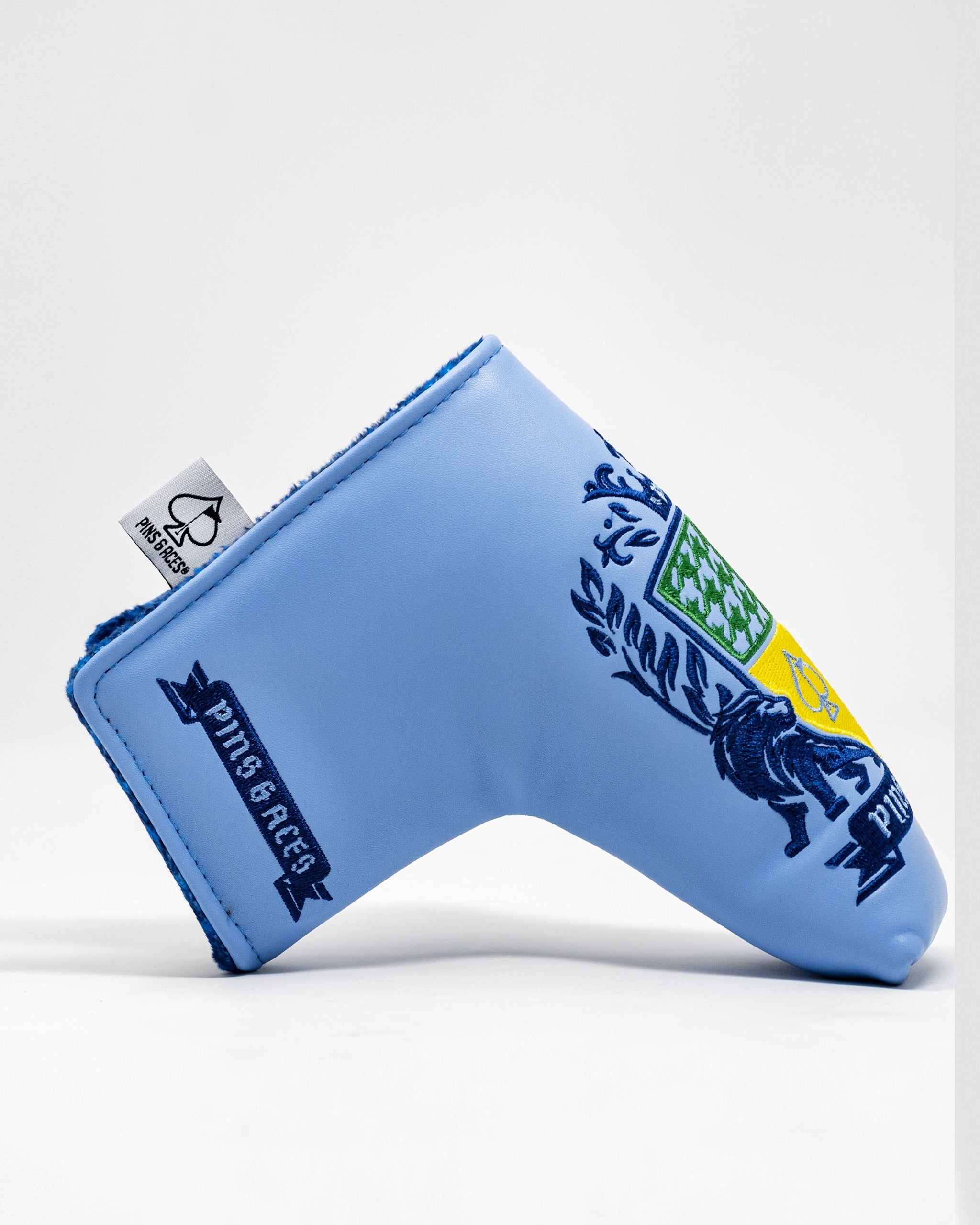 Bold blue blade putter cover featuring a vibrant coat of arms design, perfect for golfers seeking unique style.