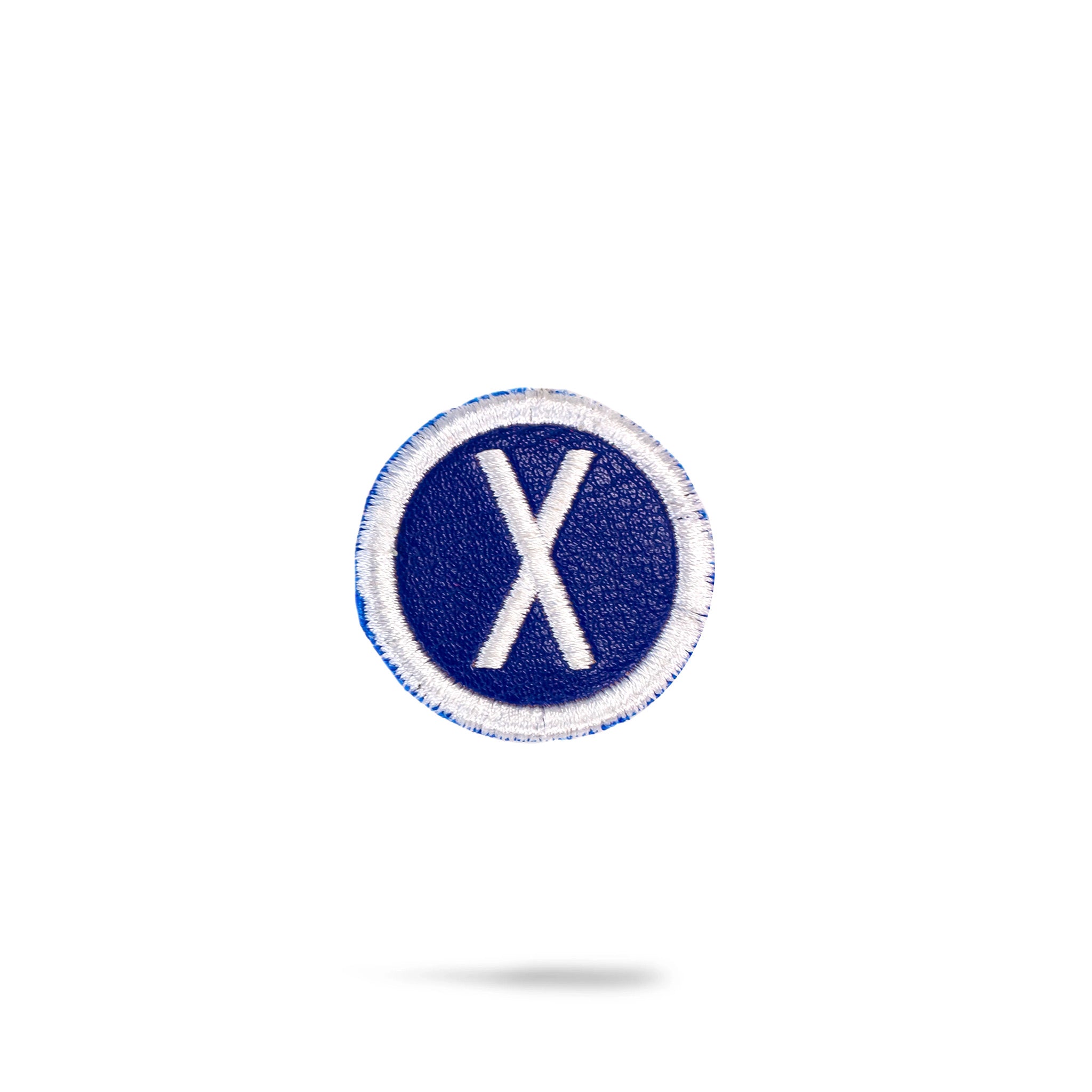 Blue headcover patch featuring a white embroidered "X" in a circular design, perfect for personalizing golf gear.