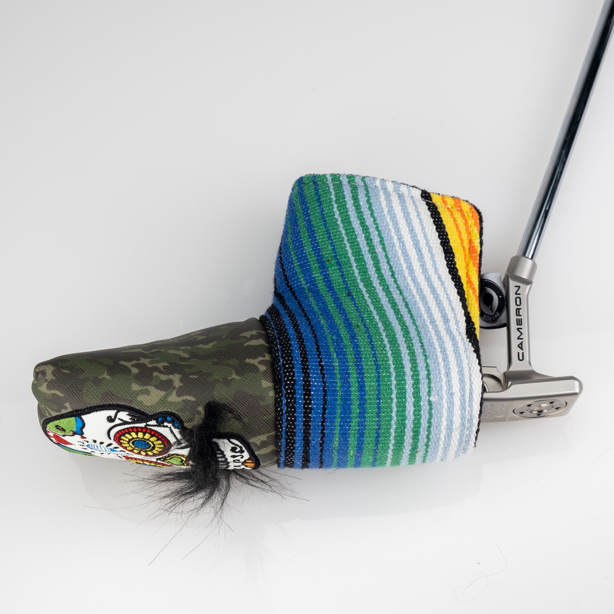Green camo putter cover featuring a mustache sugar skull design and colorful striped accents for a bold golf accessory.