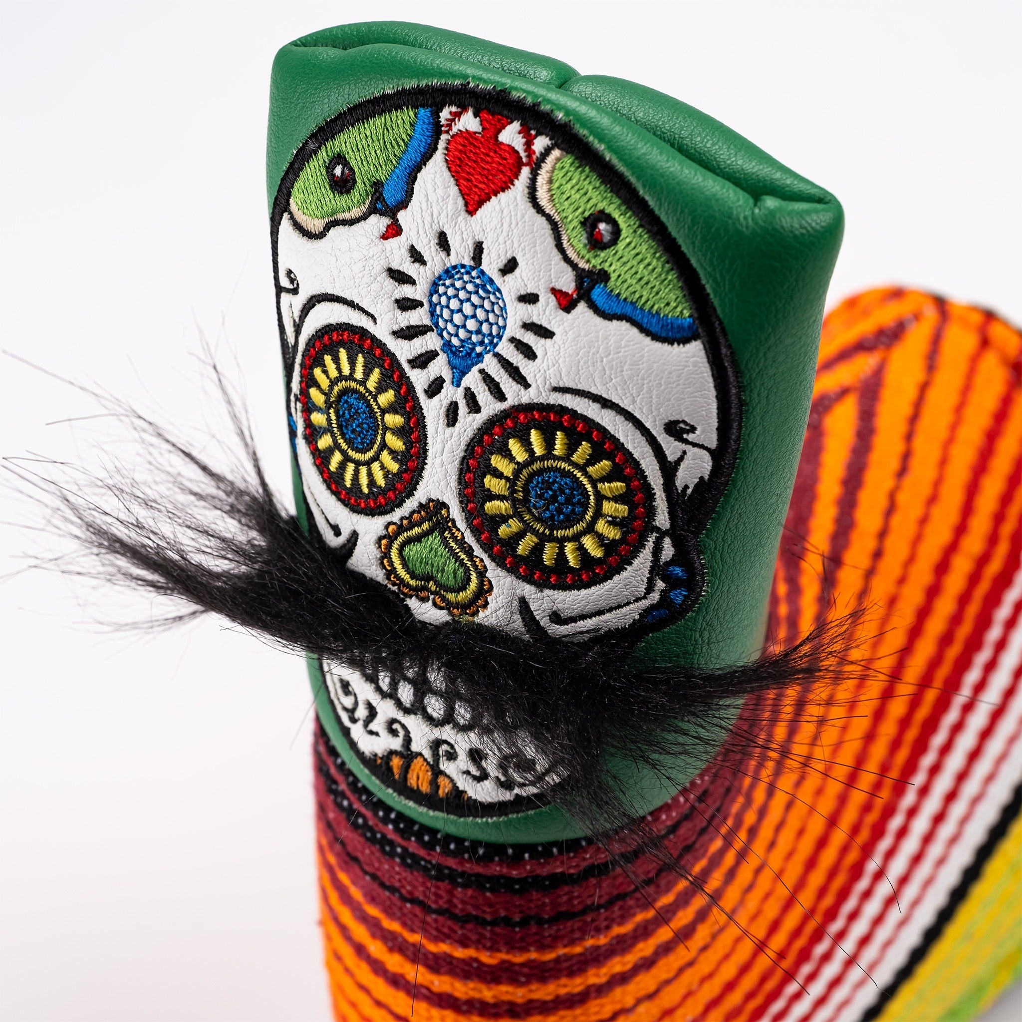 Vibrant green putter cover featuring a mustache sugar skull design with intricate embroidery and colorful patterns.