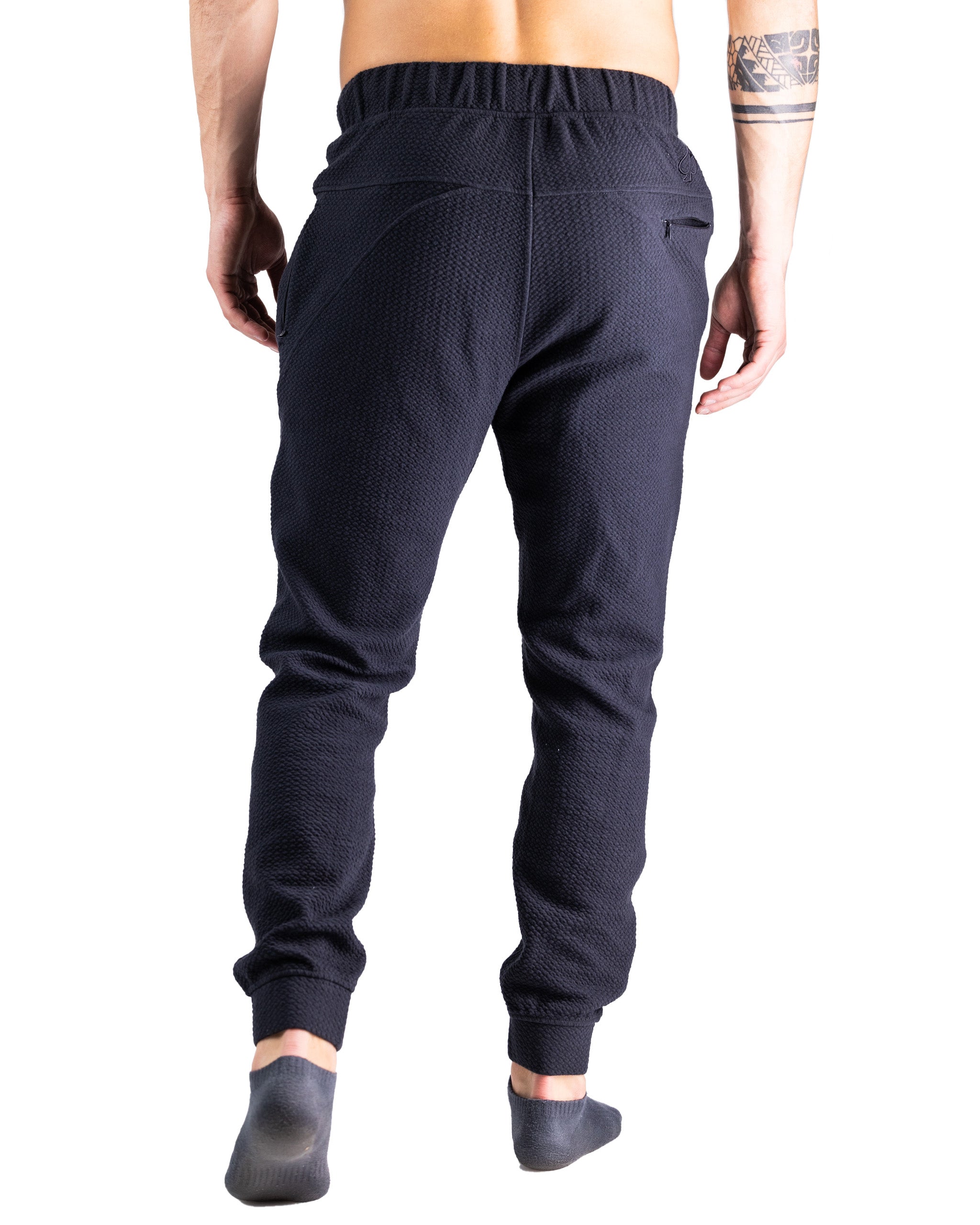 Men's obsidian waffle-knit joggers featuring a comfortable elastic waistband and tapered fit for a stylish, relaxed look.