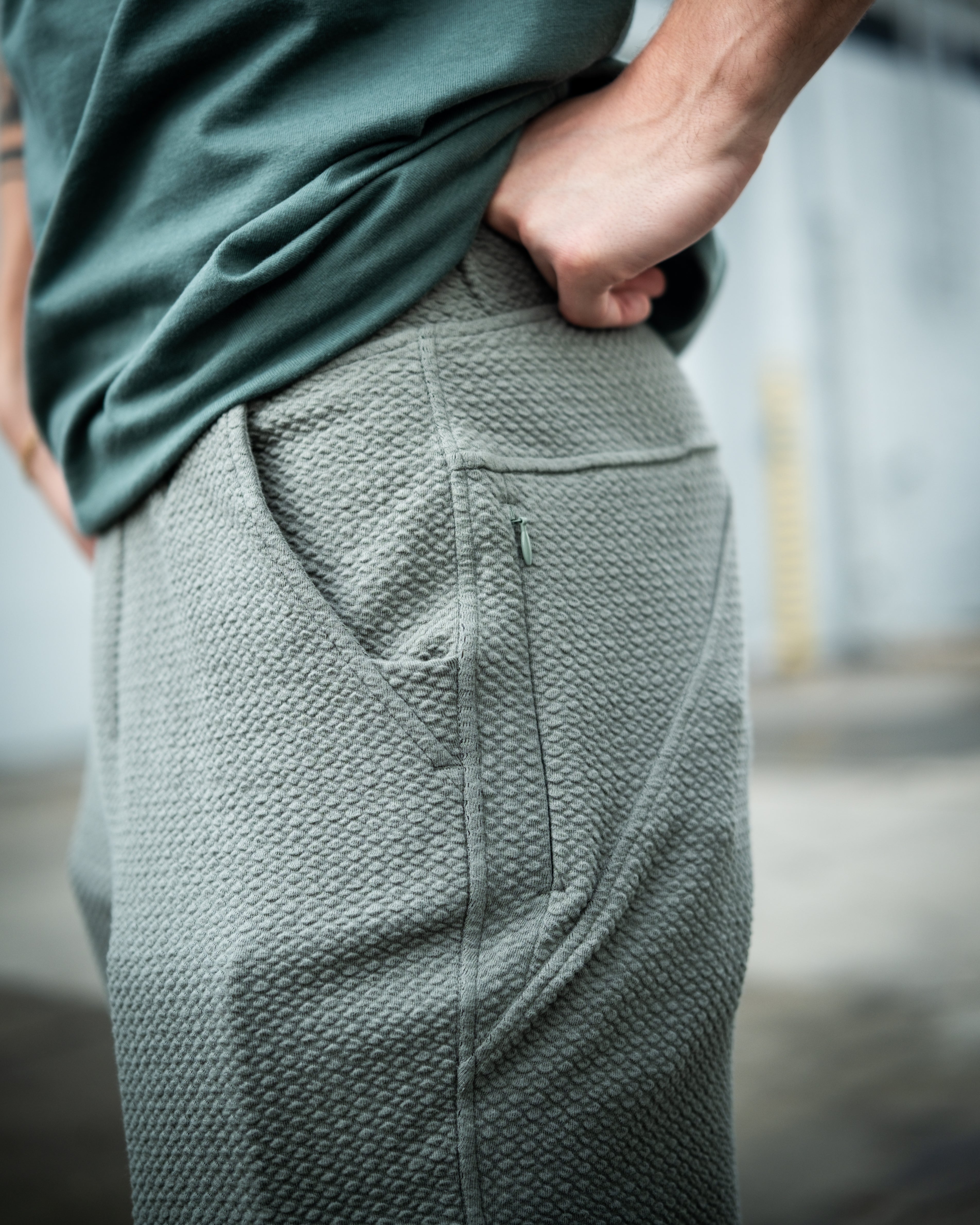 Sage green waffle knit jogger with side pocket, showcasing a textured fabric and relaxed fit for comfort and style.
