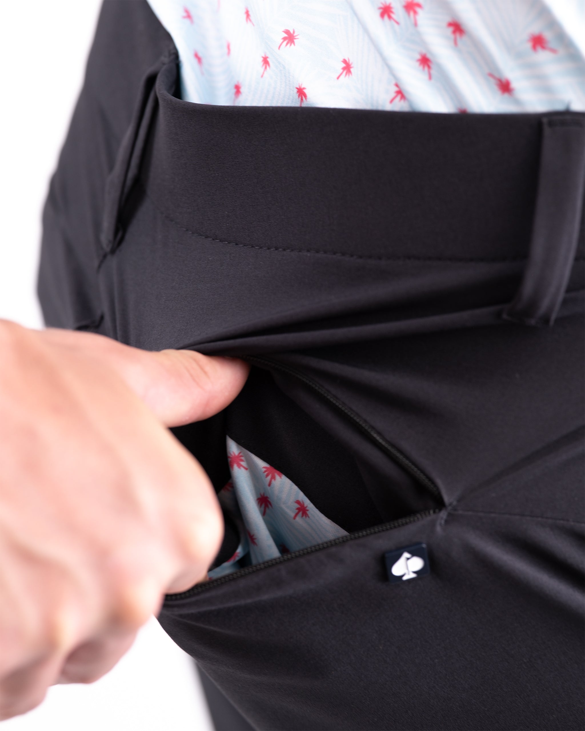 Black performance shorts featuring a sleek design and functional pockets for golfers seeking comfort and style.