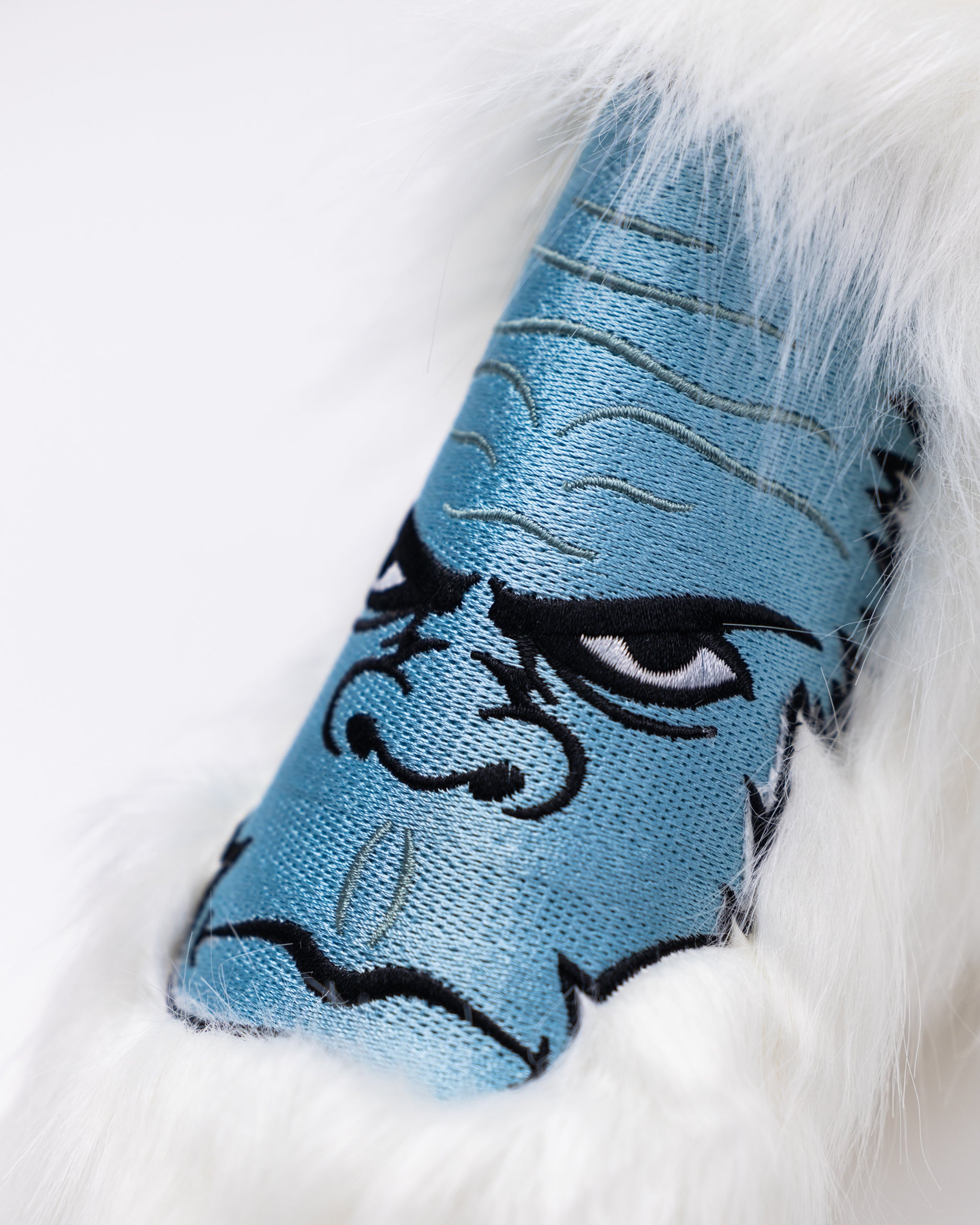 Yeti Blade Putter Cover featuring a blue design with a fierce yeti face and soft white fur trim for bold golf style.