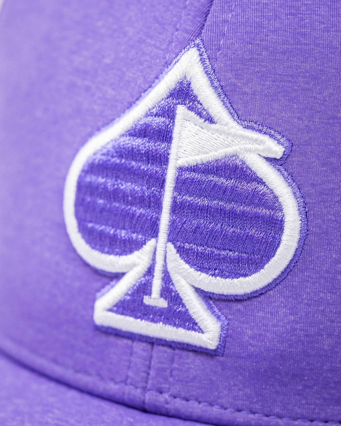 Lavender Performance Spade Hat featuring a bold embroidered spade logo, perfect for stylish golfers on the course.