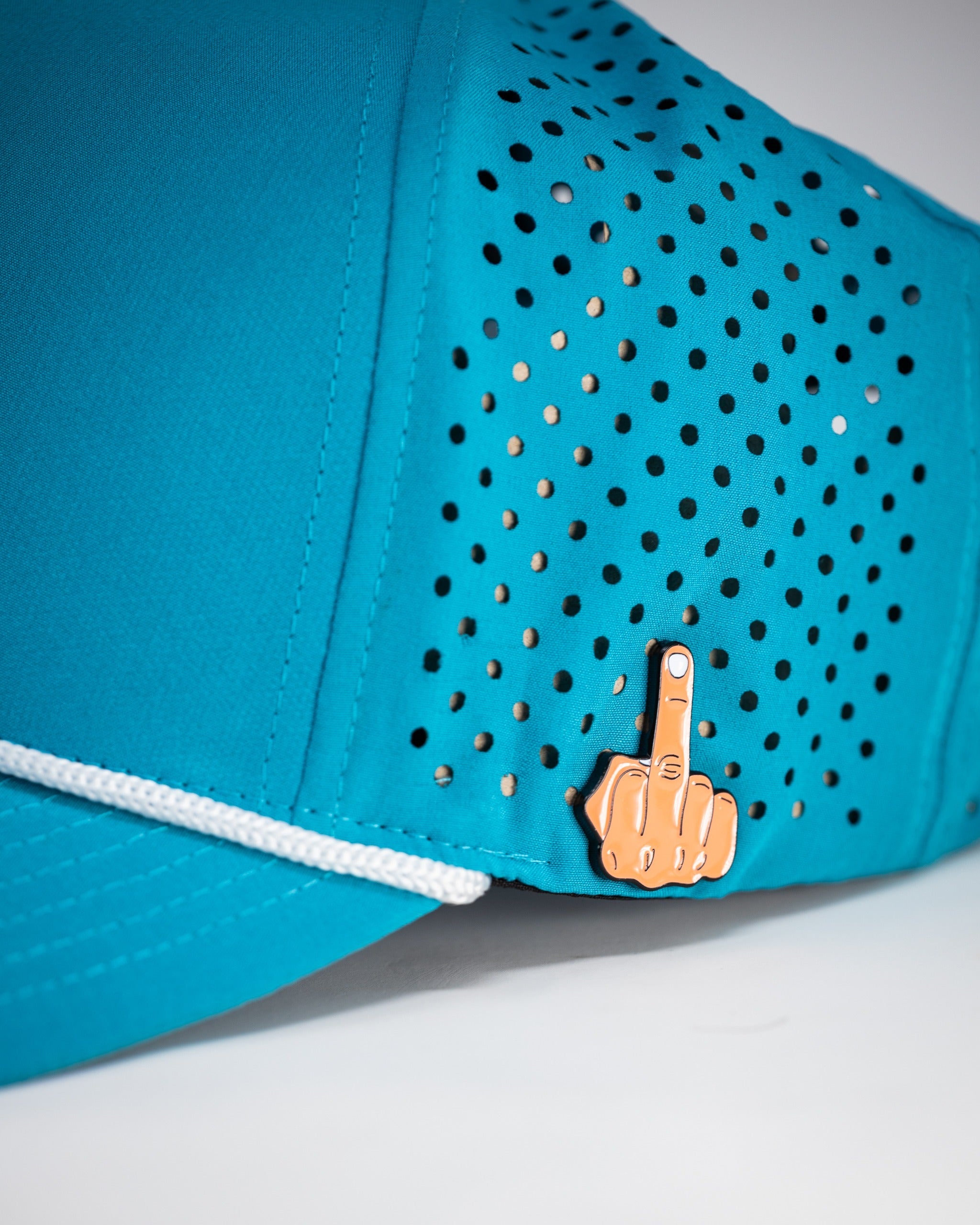 Perforated baby blue rope hat featuring a unique finger gesture pin for a bold golf style.