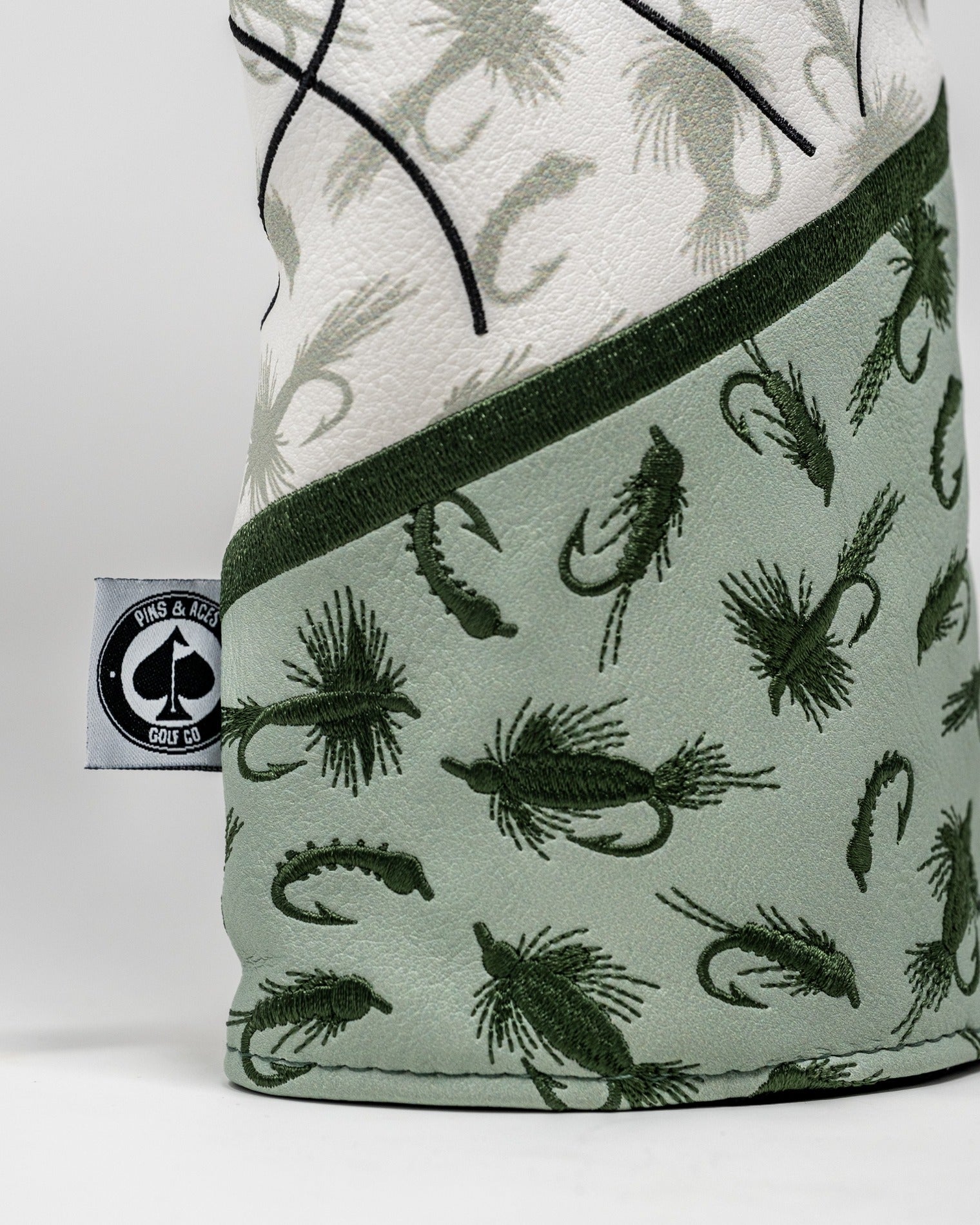 Trout driver cover featuring a unique design with fish patterns and a stylish green color scheme for golfers.