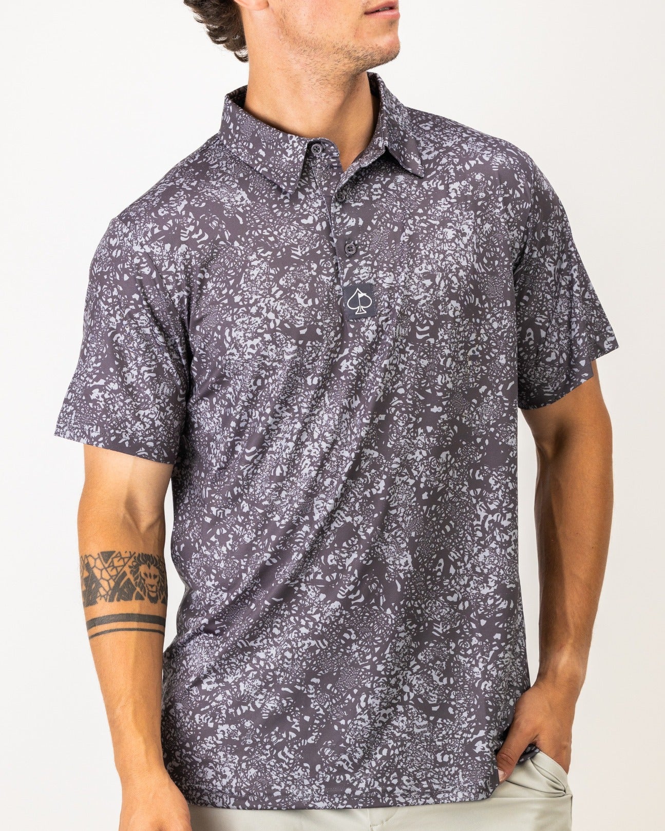 Men's short-sleeve golf shirt in volcanic ash with a bold floral pattern, designed for stylish performance on the course.