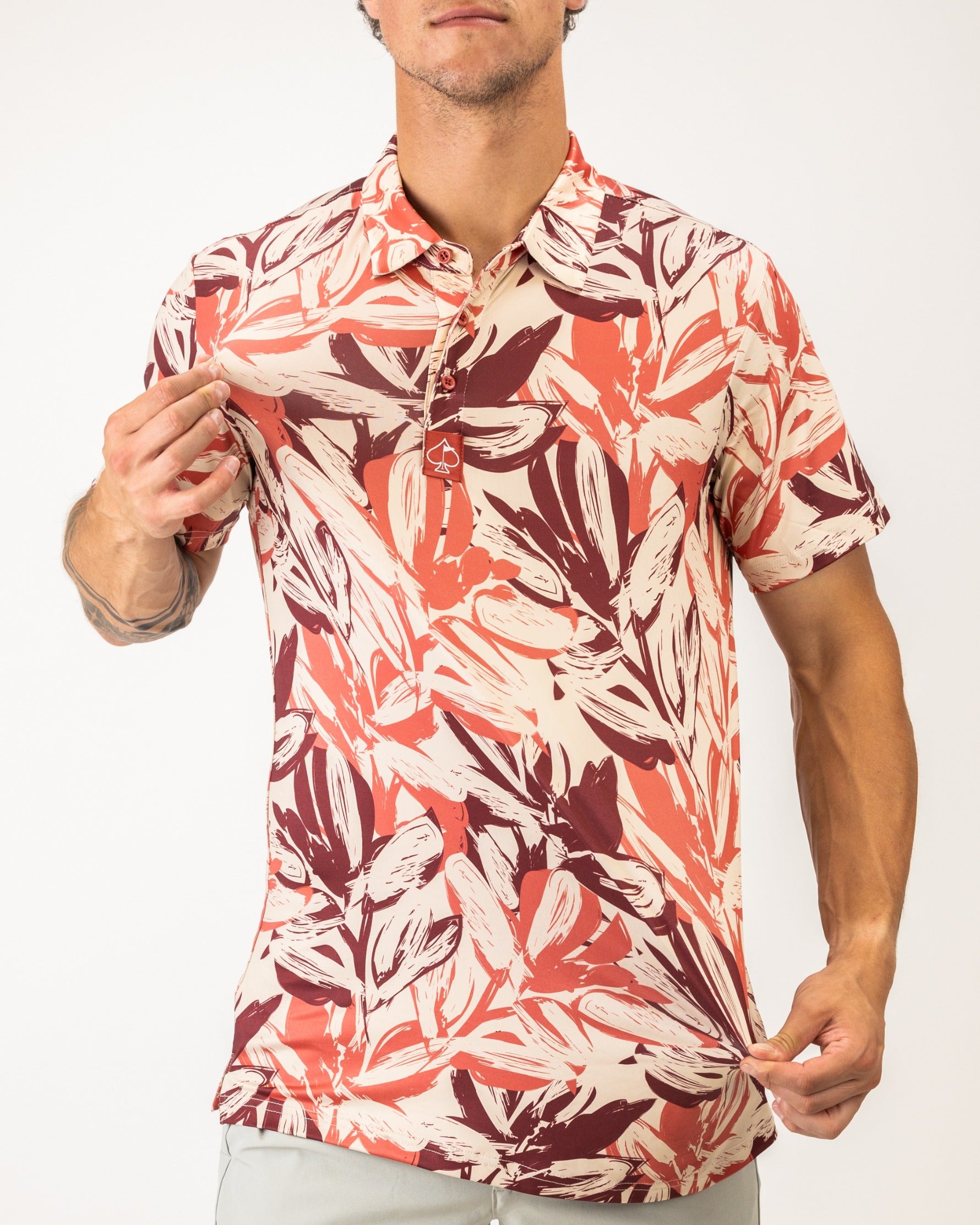 Men's brushed floral golf shirt featuring a vibrant leaf pattern in warm tones, perfect for stylish play on the course.