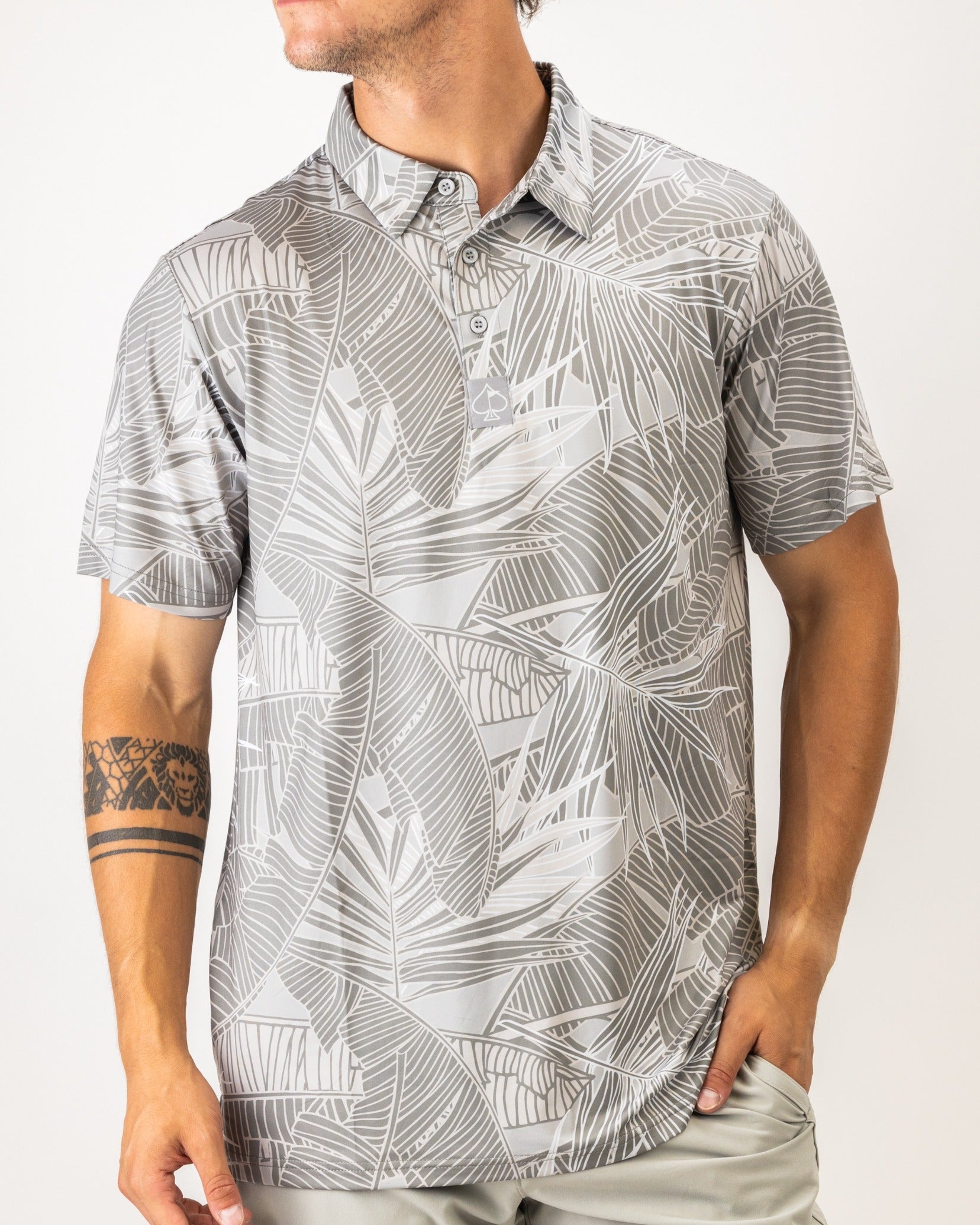 Men's medium polo featuring a stylish gray palm leaf pattern, perfect for a bold look on the golf course.