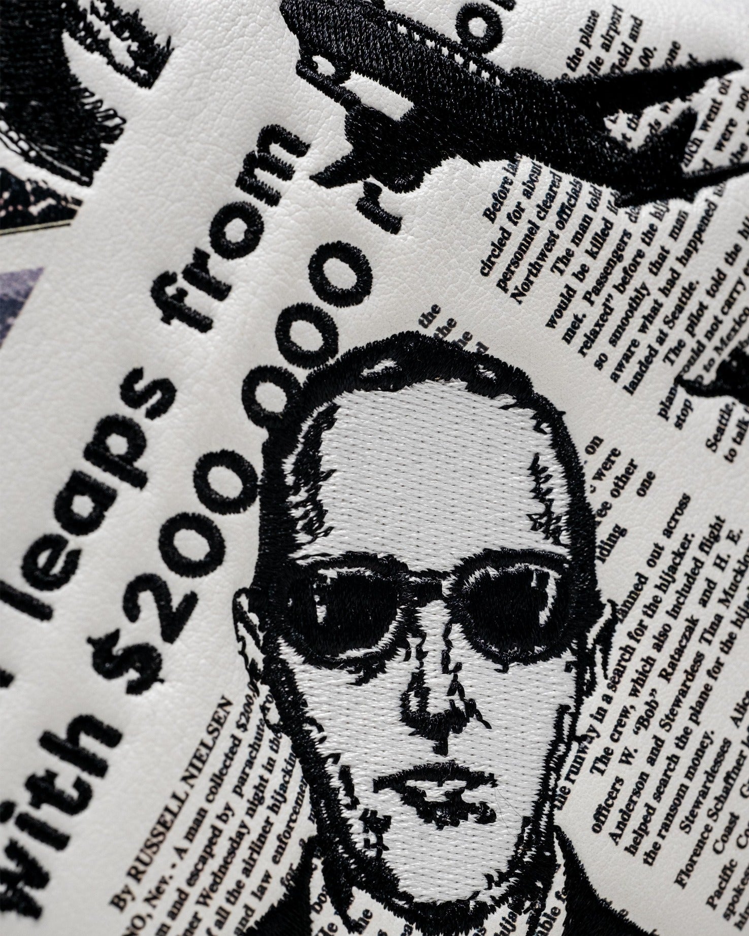 D.B. Cooper mallet putter cover featuring a bold design with newspaper clippings and a graphic of a man in sunglasses.