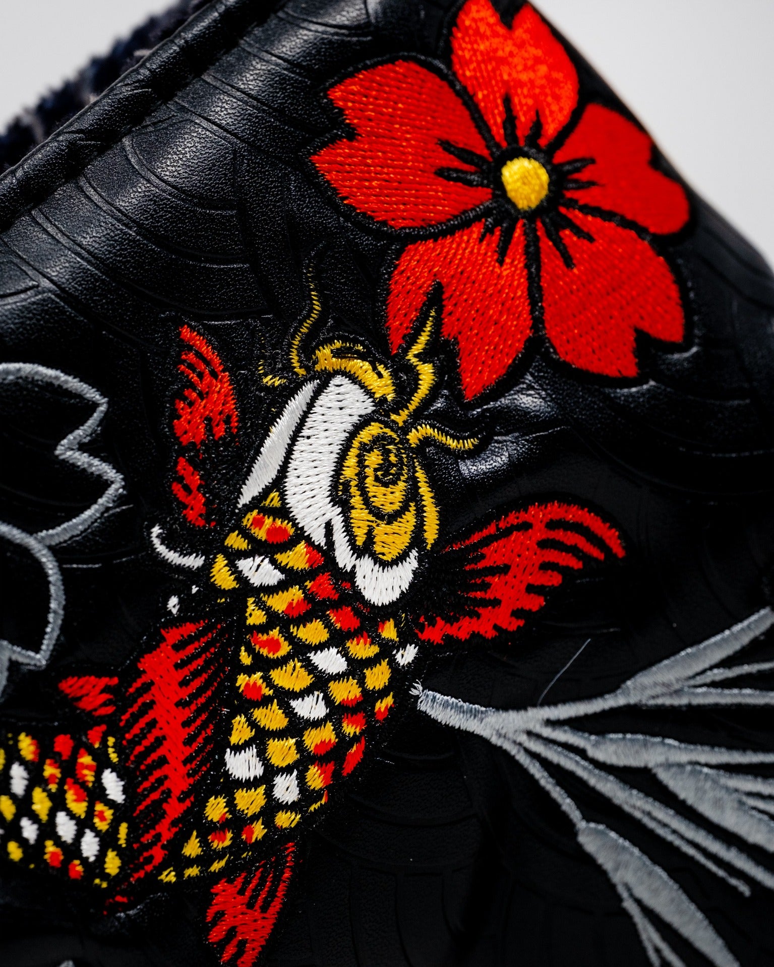 Koi Flow Blade Putter Cover featuring intricate embroidery of a koi fish and a red flower on a black background.