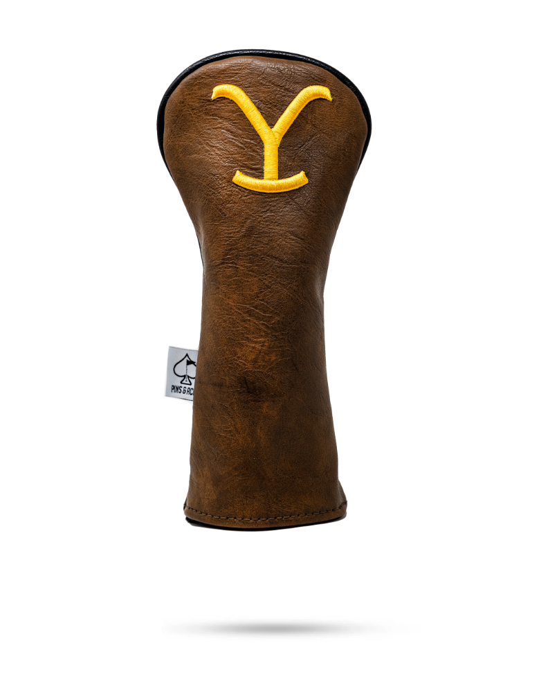 Brown leather fairway cover featuring a bold yellow Yellowstone logo, designed for golfers seeking unique style on the course.