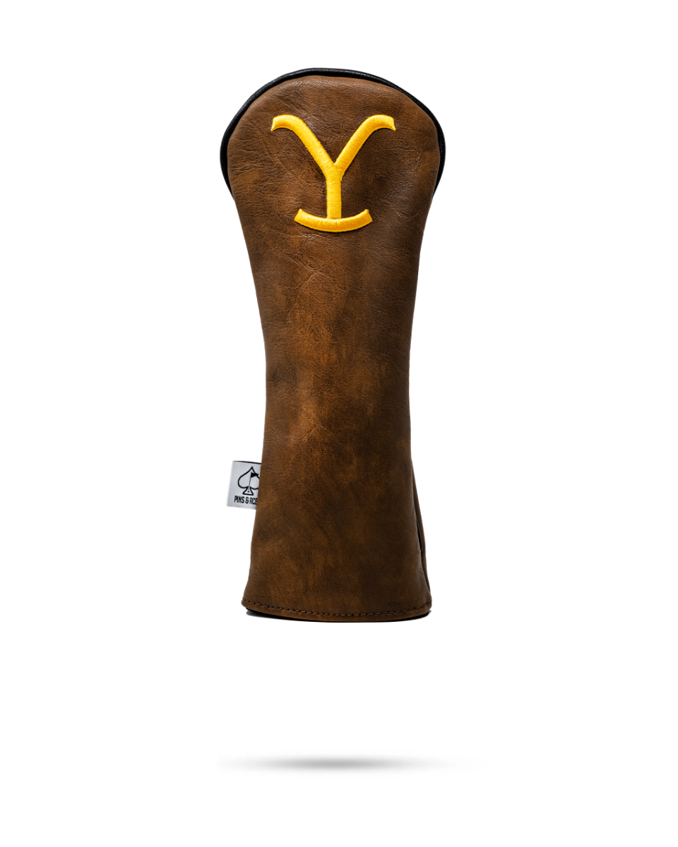 Brown leather hybrid golf club cover featuring a yellow "Y" logo, designed for golfers seeking unique style on the course.