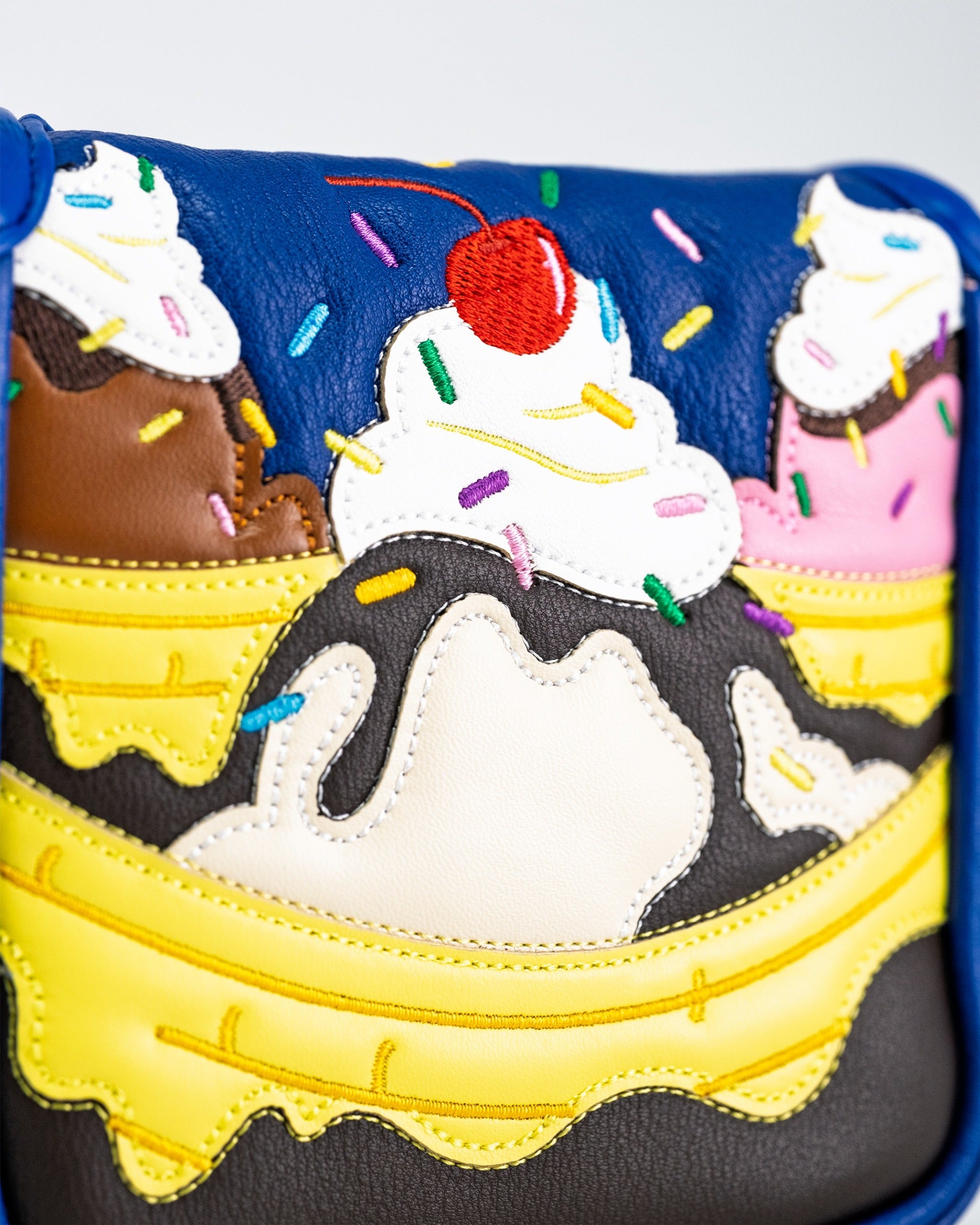 Colorful mallet putter cover featuring a banana split design with ice cream, sprinkles, and a cherry on top.