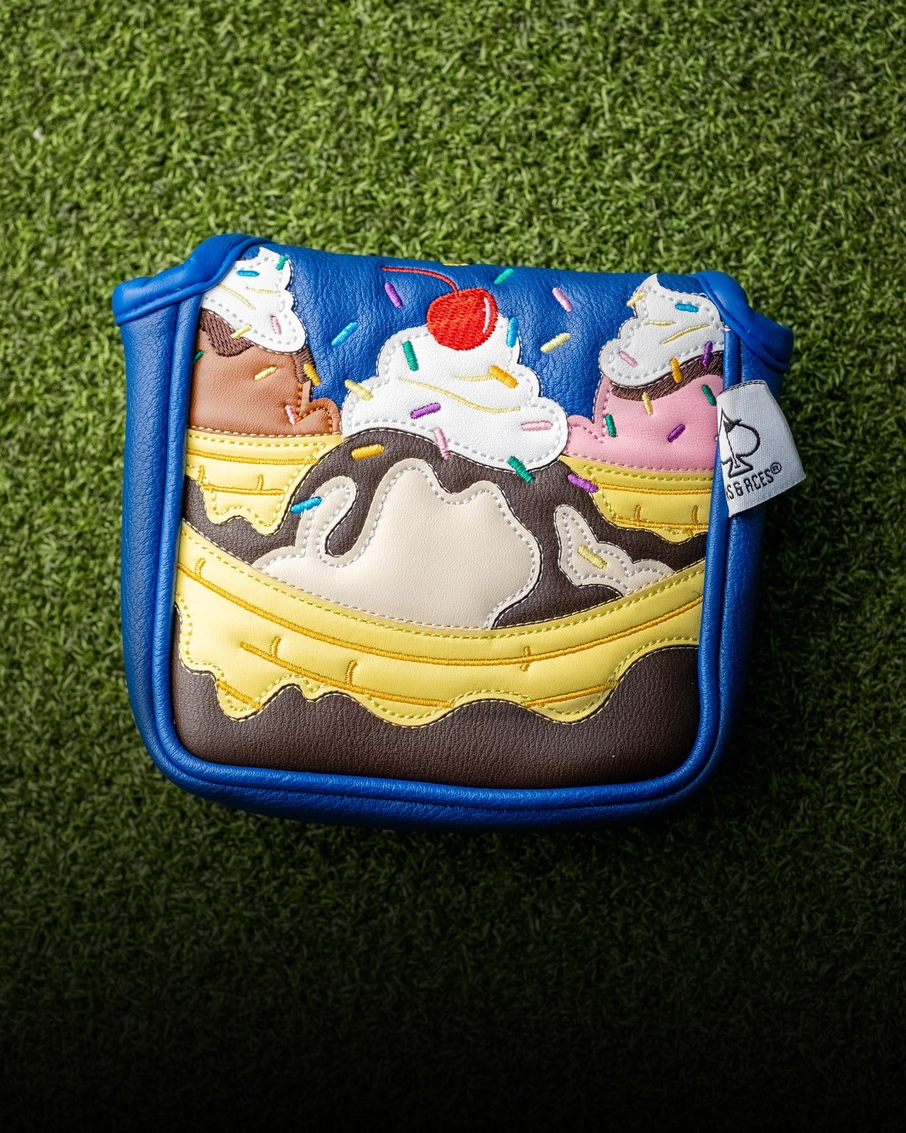 Colorful mallet putter cover designed like a banana split, featuring ice cream, sprinkles, and a cherry on top.