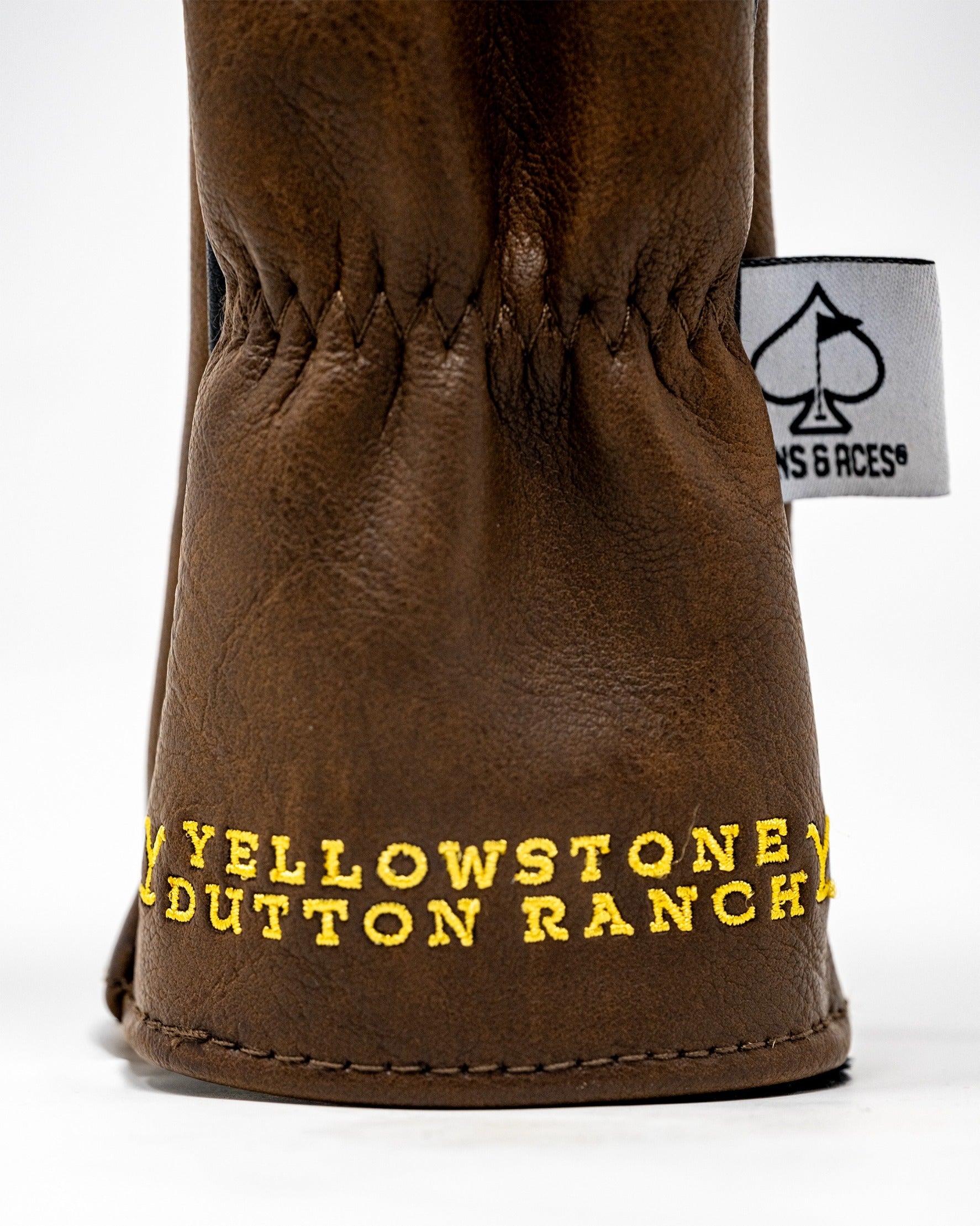 Brown hybrid golf headcover featuring "Yellowstone Dutton Ranch" in bold yellow lettering for a stylish look on the course.